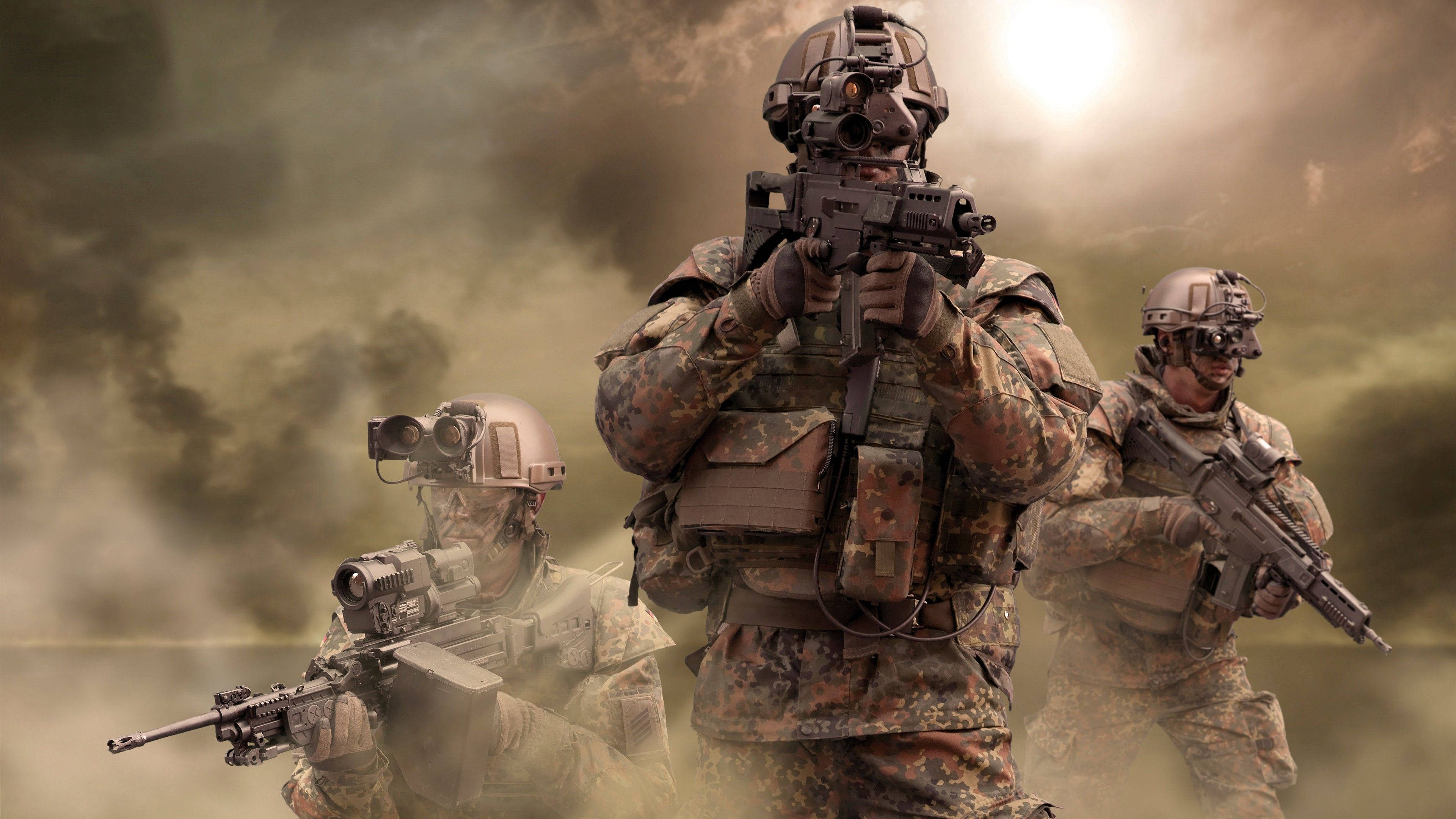 軍隊 桌布 壁紙 — 三名身穿全副戰鬥裝備的士兵在明亮的陽光下穿過煙霧和薄霧前進。