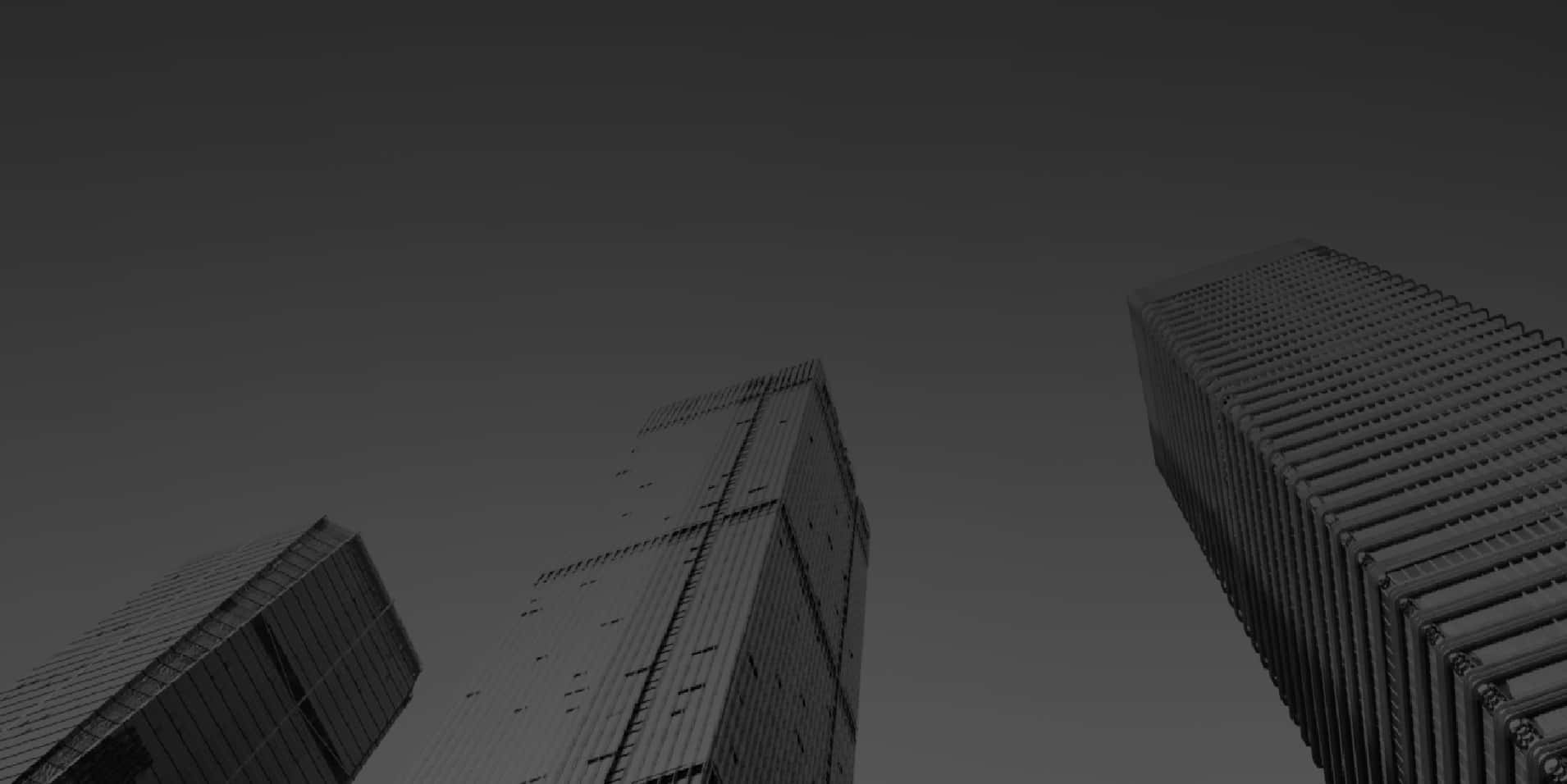 Twitter Header 桌布 壁紙 — 三座高聳摩天大樓穿透漸層灰色天空的單色低角度視圖。