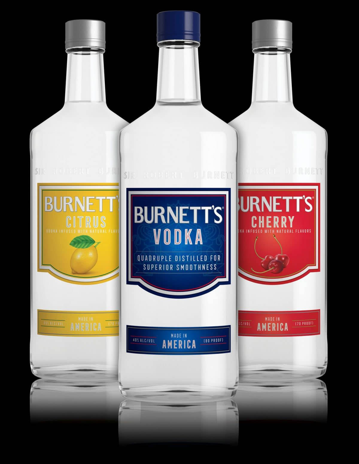 drinks 桌布 壁紙 — 三瓶 Burnett's 伏特加酒（柑橘、櫻桃和原味）排列在反光的黑色表面上，帶有鮮豔大膽的標籤。