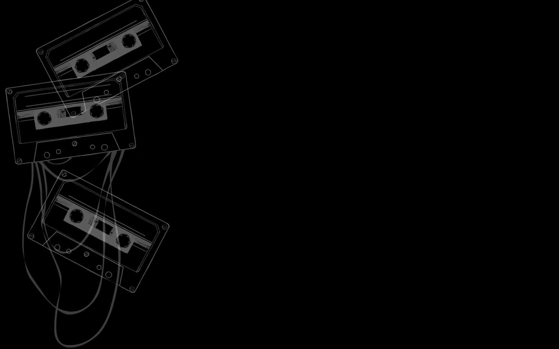 Edgy Aesthetic 桌布 壁紙 — 三盒復古卡式錄音帶纏繞著電線，以對角線漂浮在極簡線條藝術的純黑背景上。