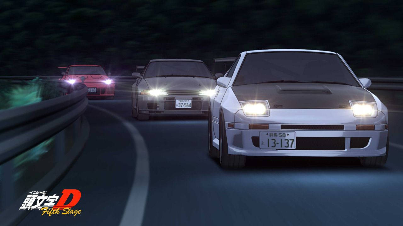 Initial 桌布 壁紙 — 三輛動漫跑車在夜間於蜿蜒的山路上奔馳，閃亮的車頭燈劃破黑暗。