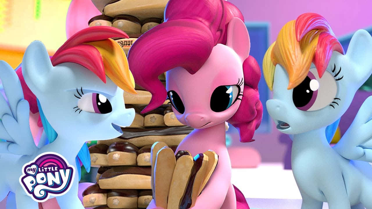 三個 My Little Pony 角色看著一堆巨大的巧克力餅乾。 — 彩虹小馬 GIF 壁紙