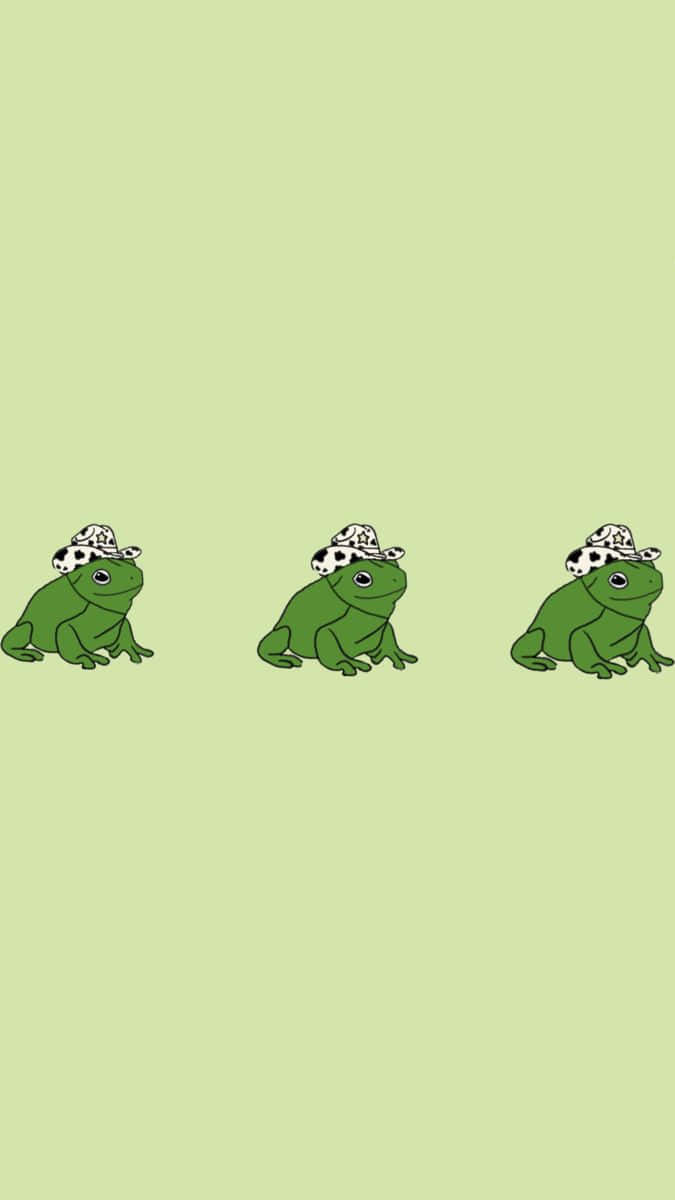 Aesthetic Kermit 桌布 壁紙 — 三隻卡通青蛙戴著大麥町圖案帽子，排成一排坐在淺綠色背景前。