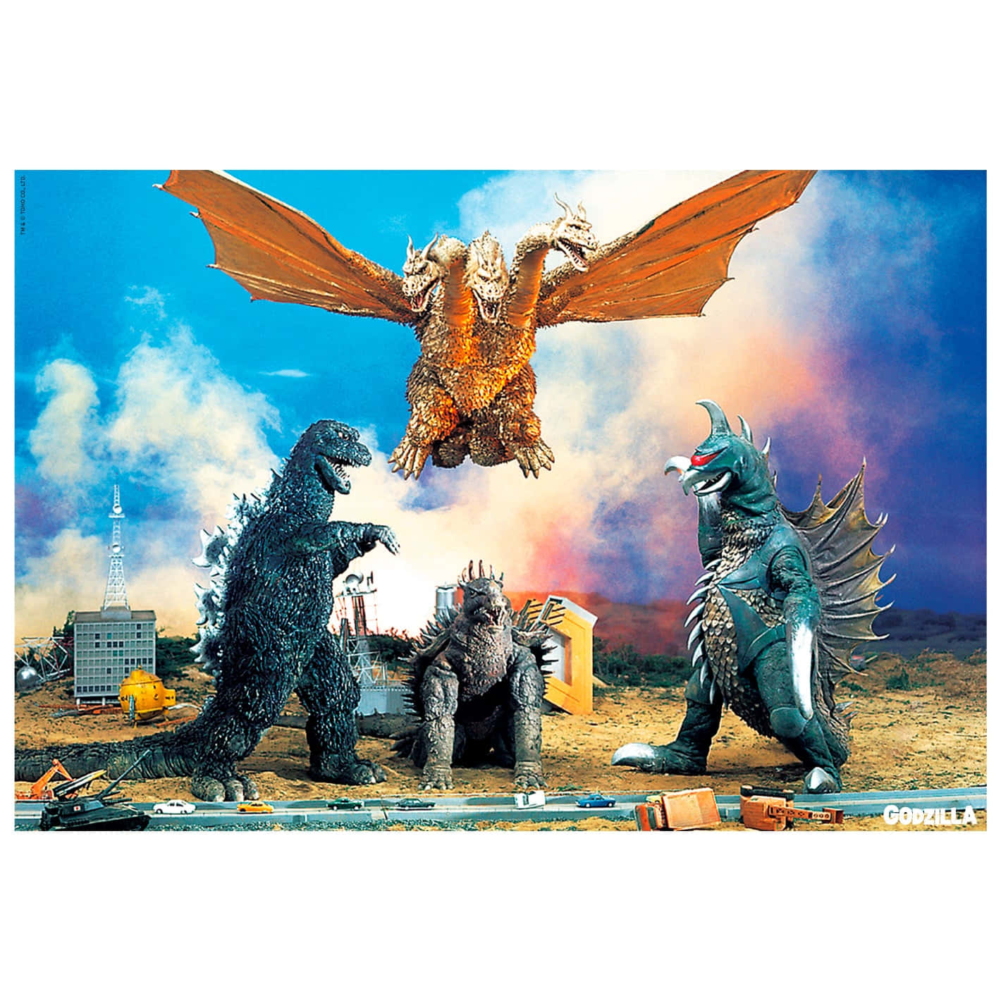Godzilla Vs Gigan 桌布 壁紙 — 三隻巨型怪獸哥吉拉、王者基多拉和另一隻怪獸在戲劇性的天空下於微型城市景觀上空戰鬥。