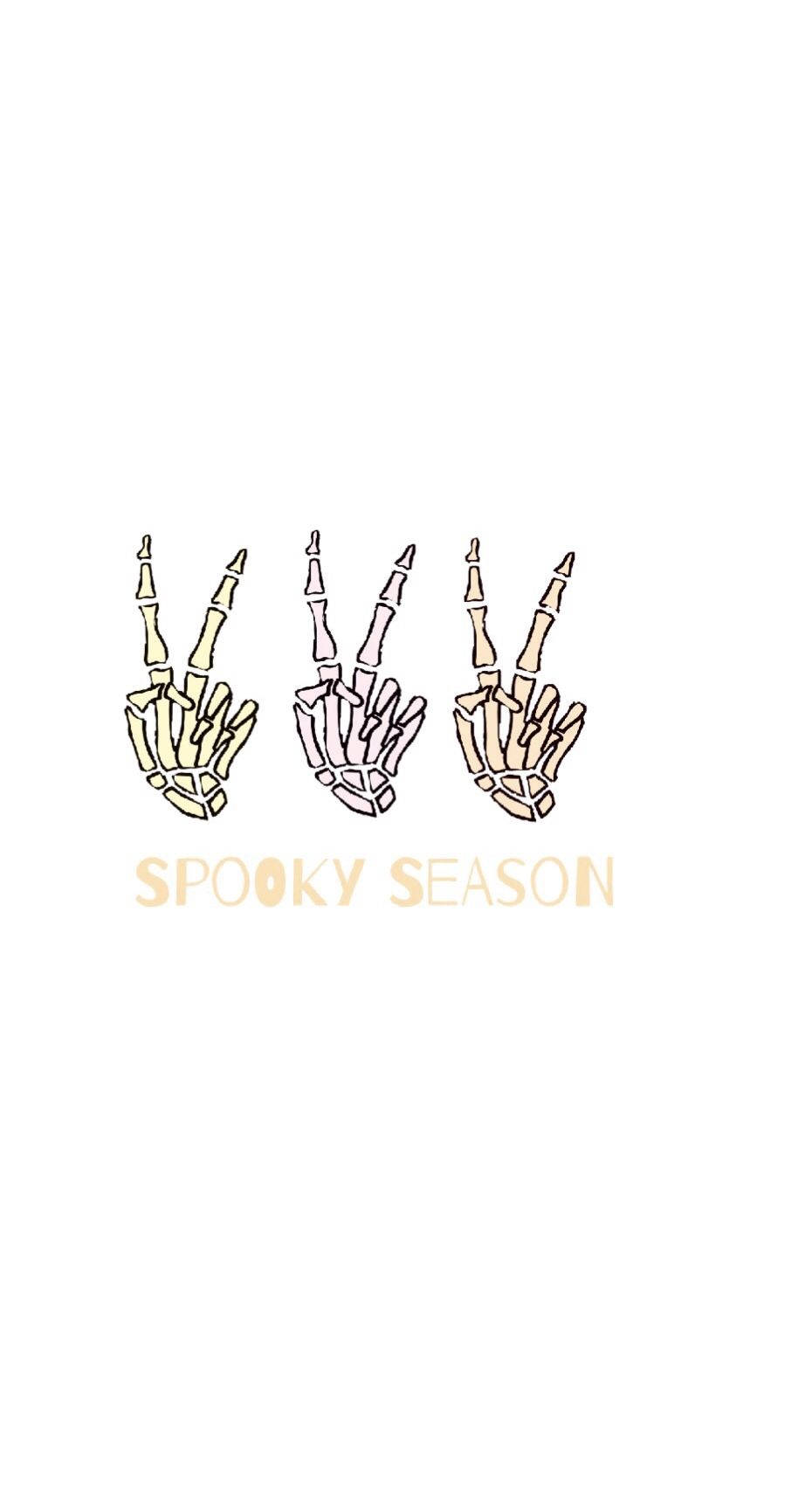 hand 桌布 壁紙 — 三隻插圖骷髏手做出和平手勢，下方有 spooky season 文字，白色背景。