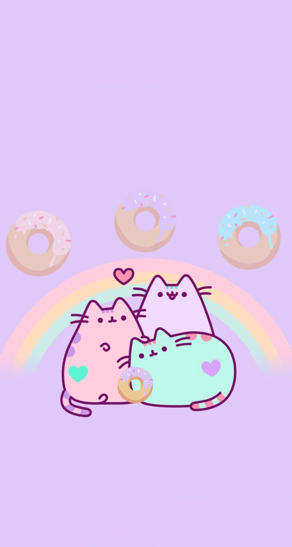 Kawaii Pusheen 桌布 壁紙 — 三隻粉彩卡通貓咪在彩虹下依偎，周圍漂浮著甜甜圈，背景為薰衣草色。