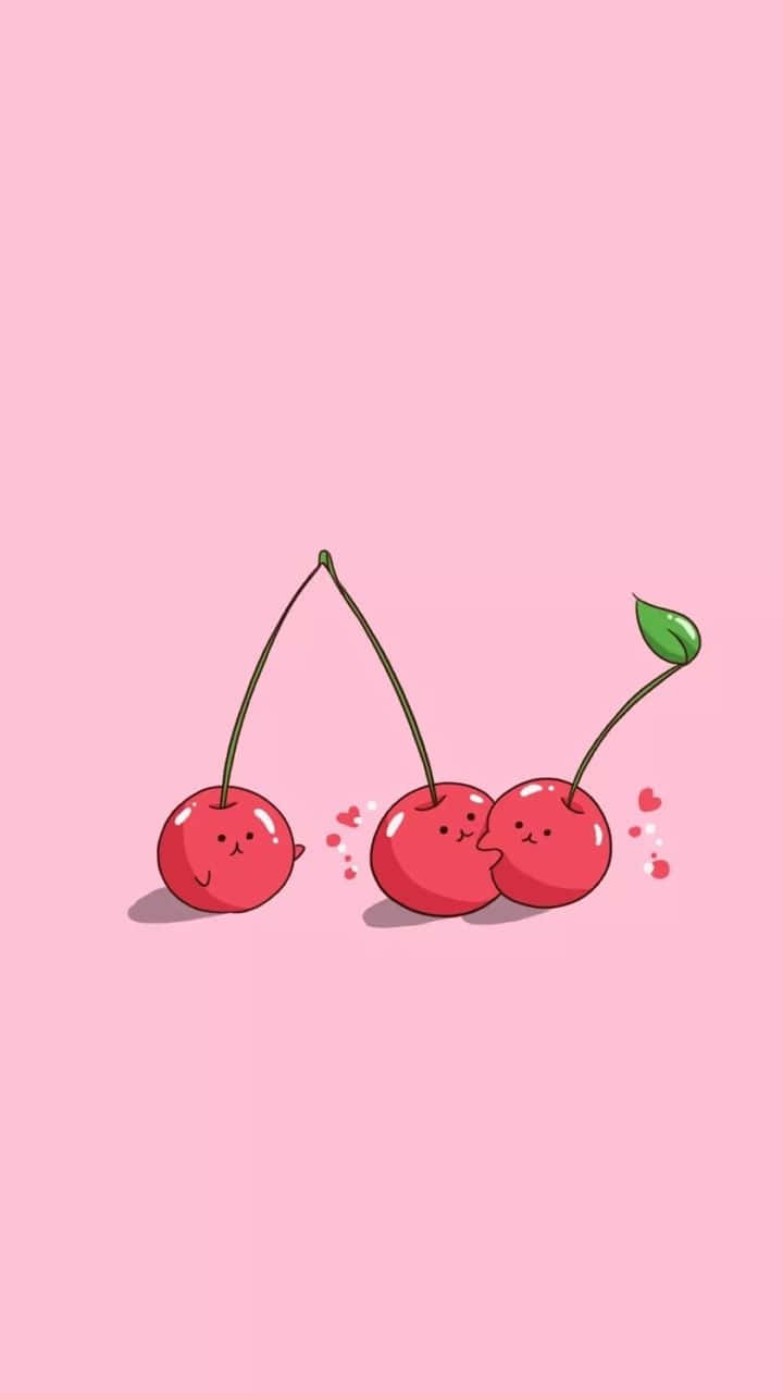Cherry Aesthetic 桌布 壁紙 — 三顆可愛卡通櫻桃，有臉和莖，在柔軟粉紅色背景上親吻，周圍有漂浮的心形。
