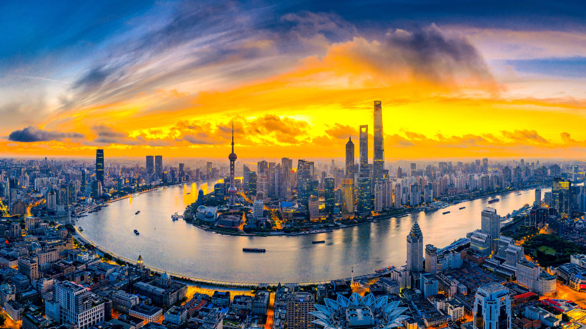 Shanghai 桌布 壁紙 — 上海天際線的鳥瞰圖，夕陽西下，金色雲彩映照在黃浦江上。
