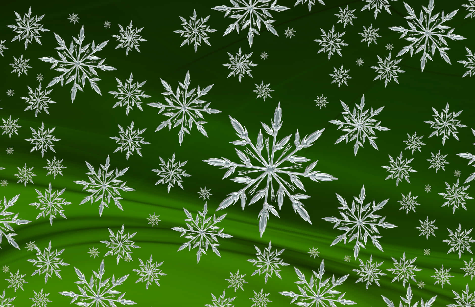 雪花 桌布 壁紙 — 不同大小的銀色雪花在豐富的漸變綠色背景上優雅地飄浮。
