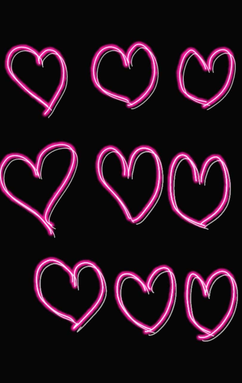 Pink Neon Aesthetic 桌布 壁紙 — 九個發光的粉紅色霓虹心形，帶有白色輪廓，在純黑色背景上以網格圖案漂浮。