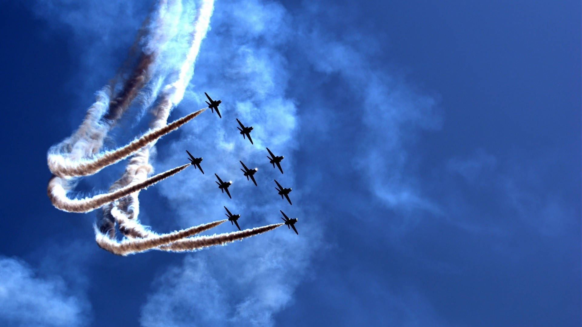 Air Force 桌布 壁紙 — 九架戰鬥機在深藍色的天空中緊密編隊飛行，留下濃厚的白色煙霧痕跡。