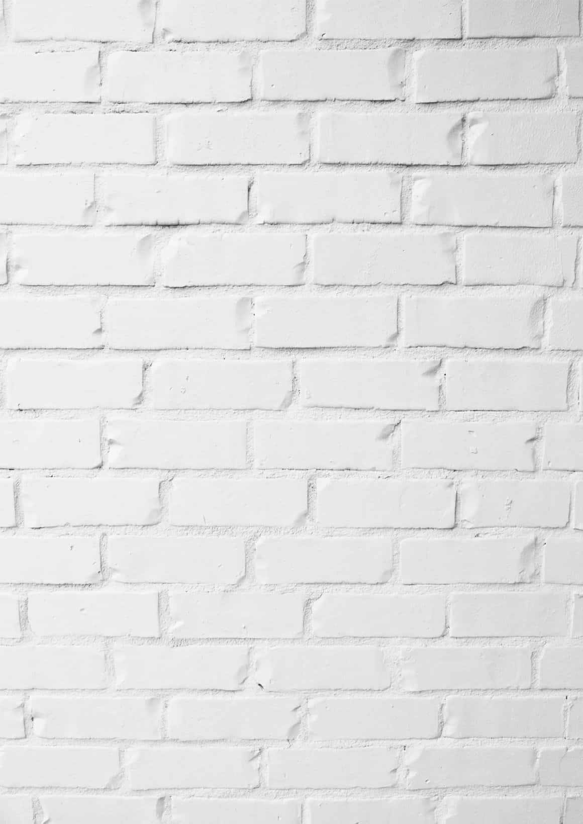 White Brick Wall 桌布 壁紙 — 乾淨的白色油漆磚牆，帶有細微紋理和砂漿線條，在柔和均勻的光線下。