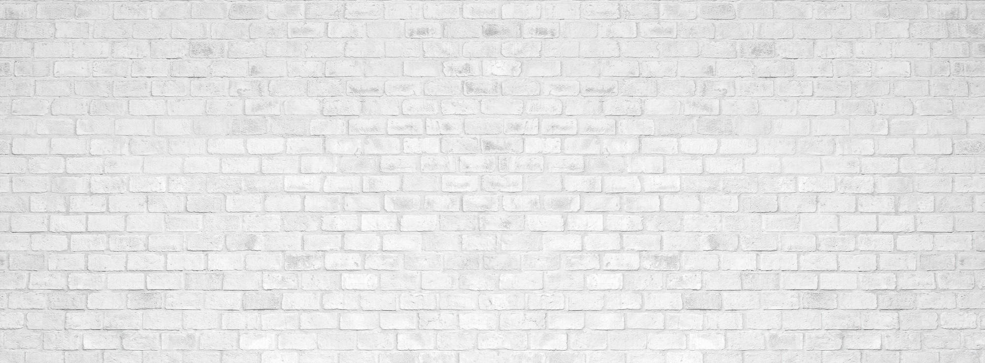 Brick 桌布 壁紙 — 乾淨的白色磚牆，帶有細微紋理和砂漿線條，營造出極簡主義的城市背景。