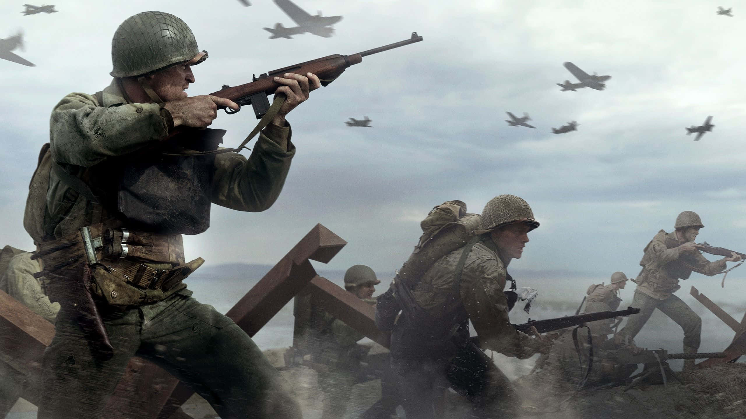 Ww2 桌布 壁紙 — 二戰裝備的士兵在煙霧和碎片中前進，戰鬥機在混亂的戰場上空飛翔。