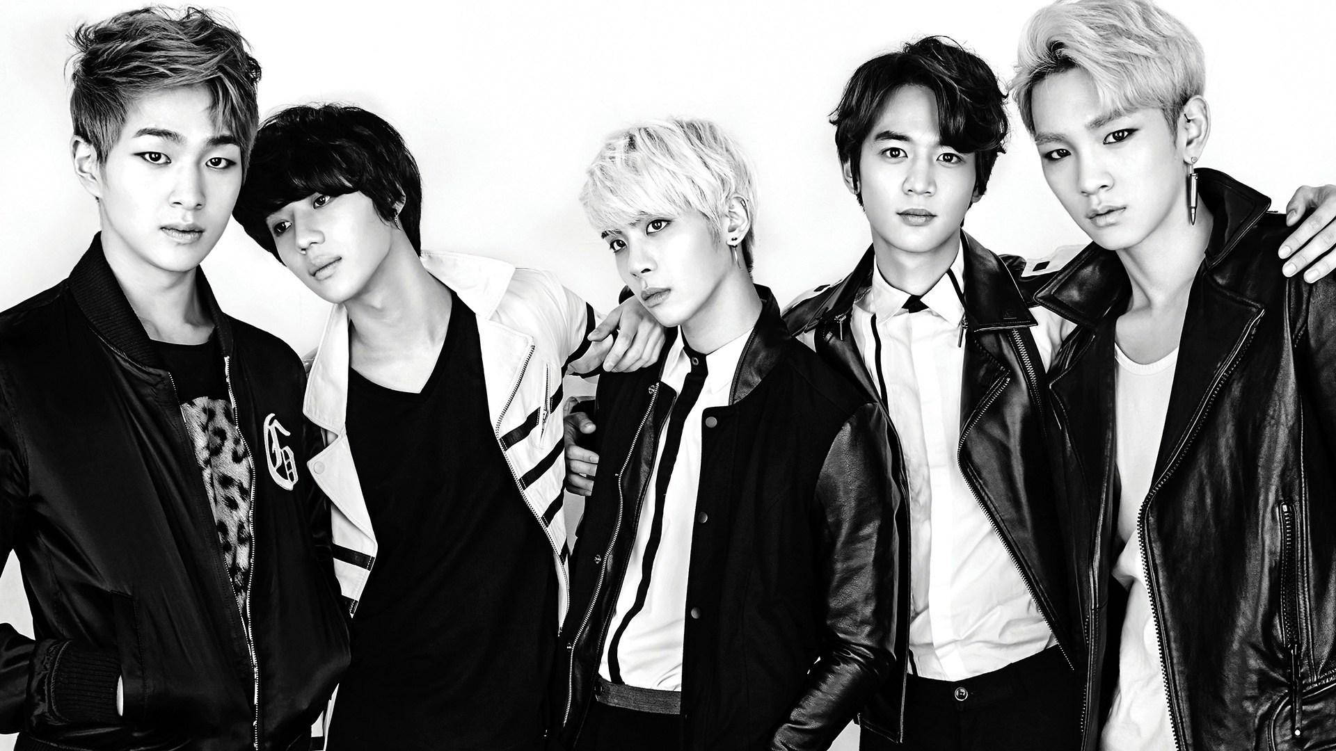 Shinee 桌布 壁紙 — 五位時尚年輕男子身穿皮夾克，在純白背景前自信擺姿勢，呈現高對比黑白照片效果。