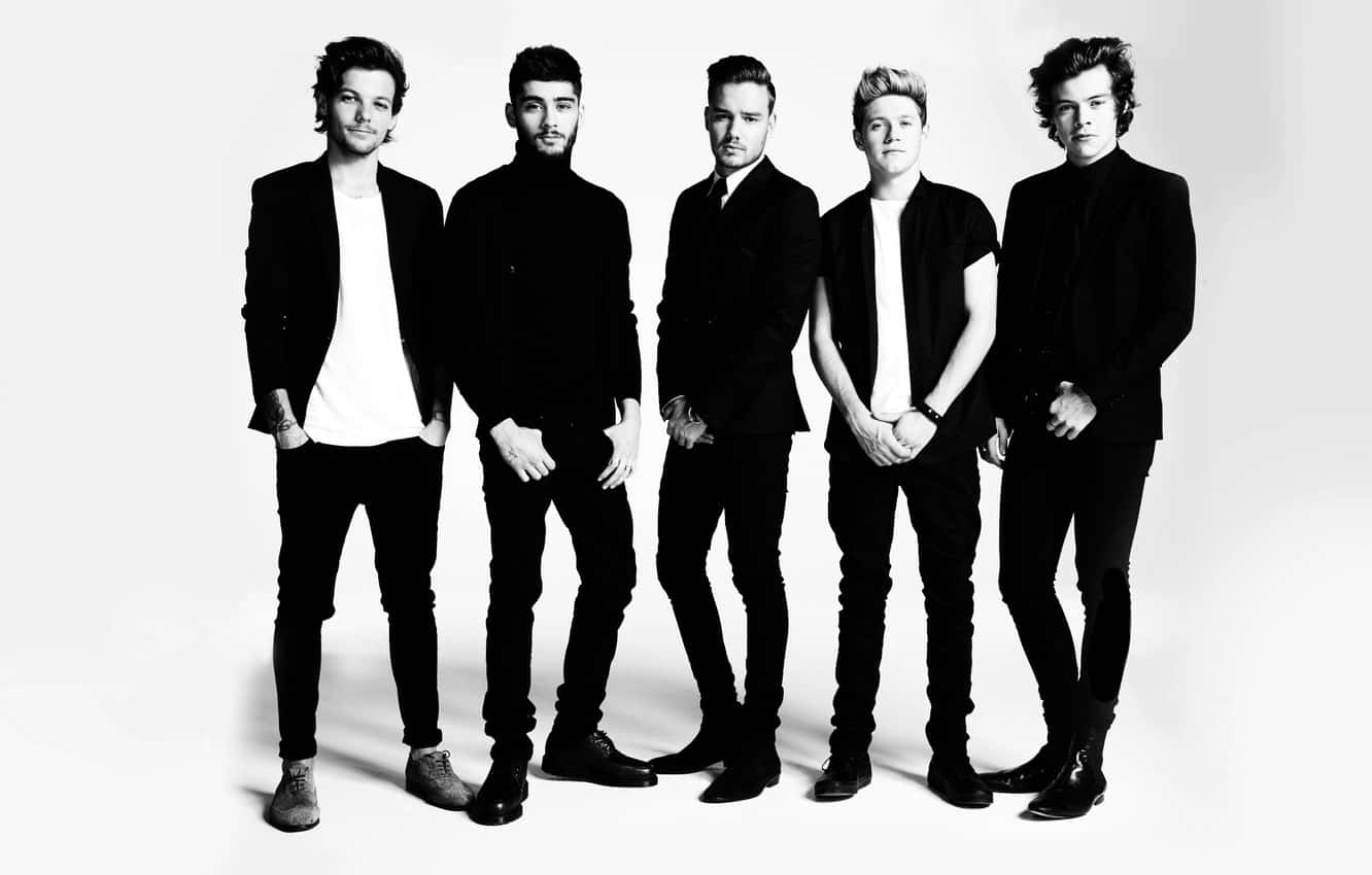 One Direction 桌布 壁紙 — 五位穿著黑色西裝和白色襯衫的時尚男士在單色工作室拍攝中，自信地擺姿勢，背景為純白色。