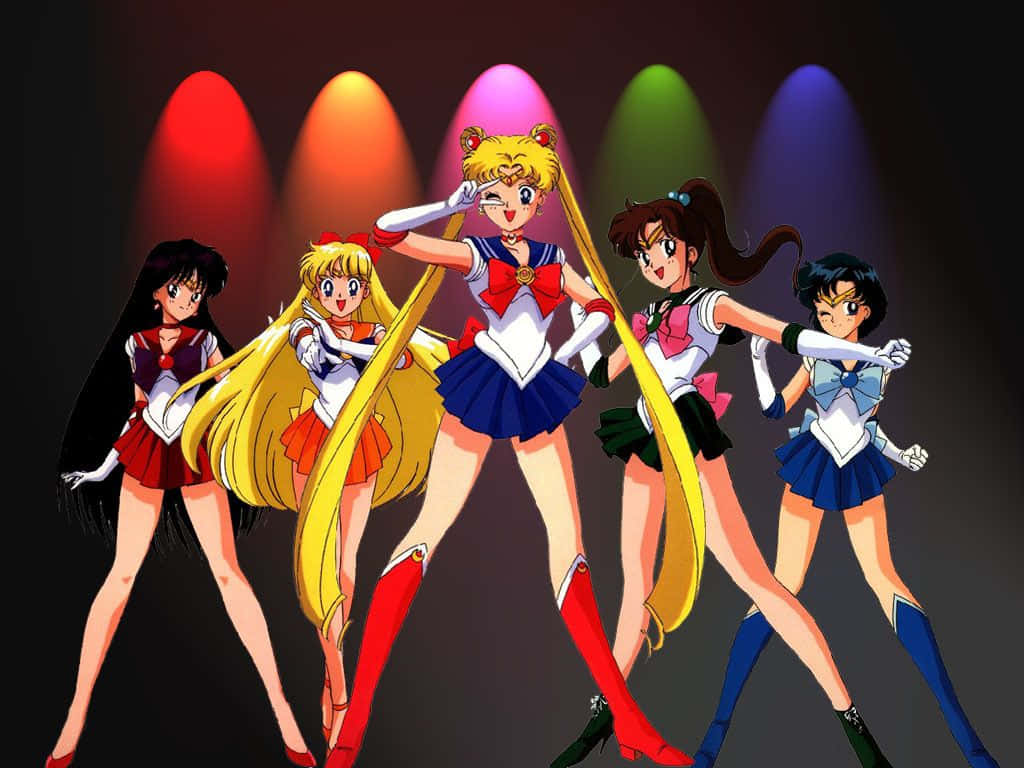 Manga Characters 桌布 壁紙 — 五位身穿水手服的動畫女主角在黑暗背景下的彩色舞台聚光燈下擺出動感姿勢。