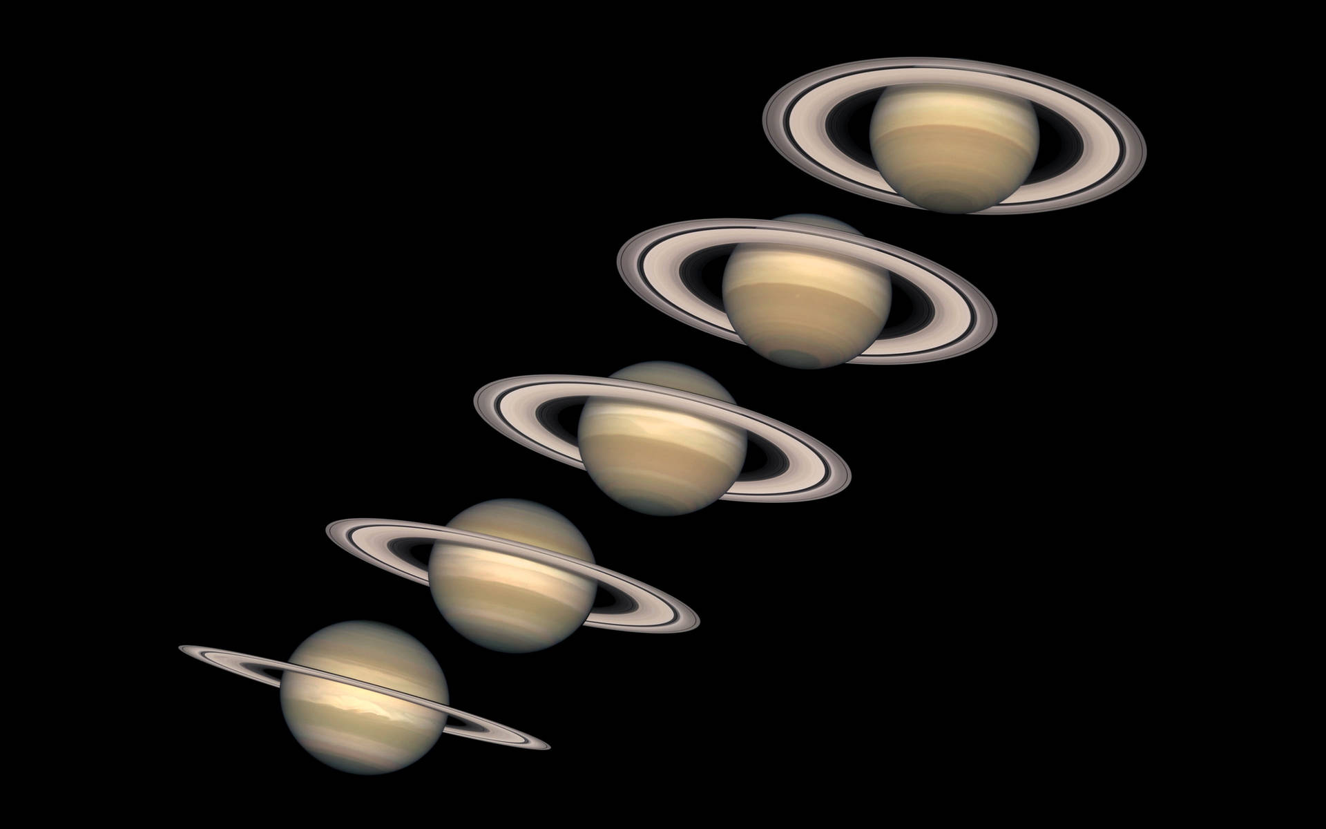 五個帶環的土星行星在太空中斜向排列。