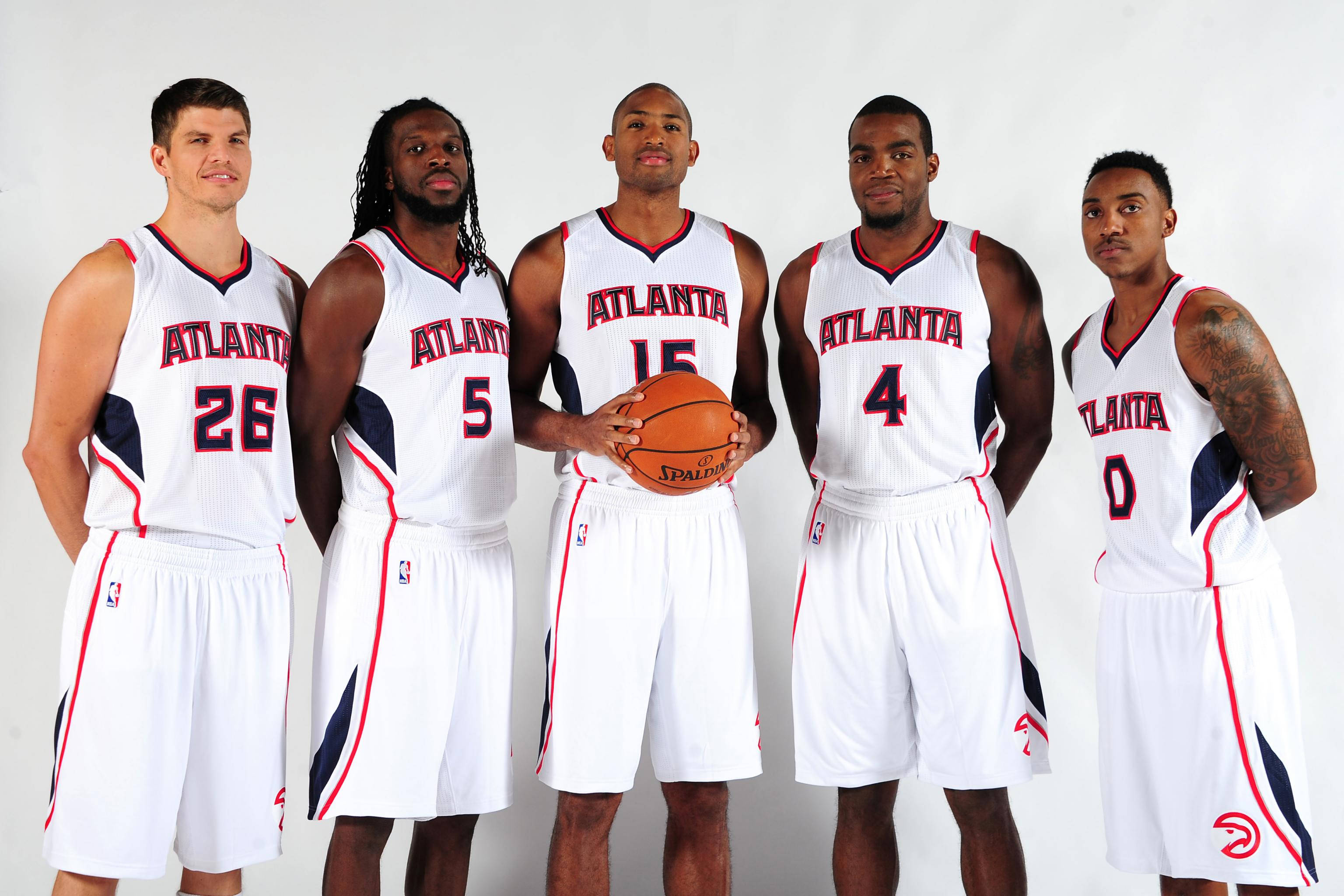 Hawks 桌布 壁紙 — 五名身穿白色球衣的亞特蘭大老鷹隊籃球運動員在純白色背景前自信地擺姿勢，其中一人手持籃球。