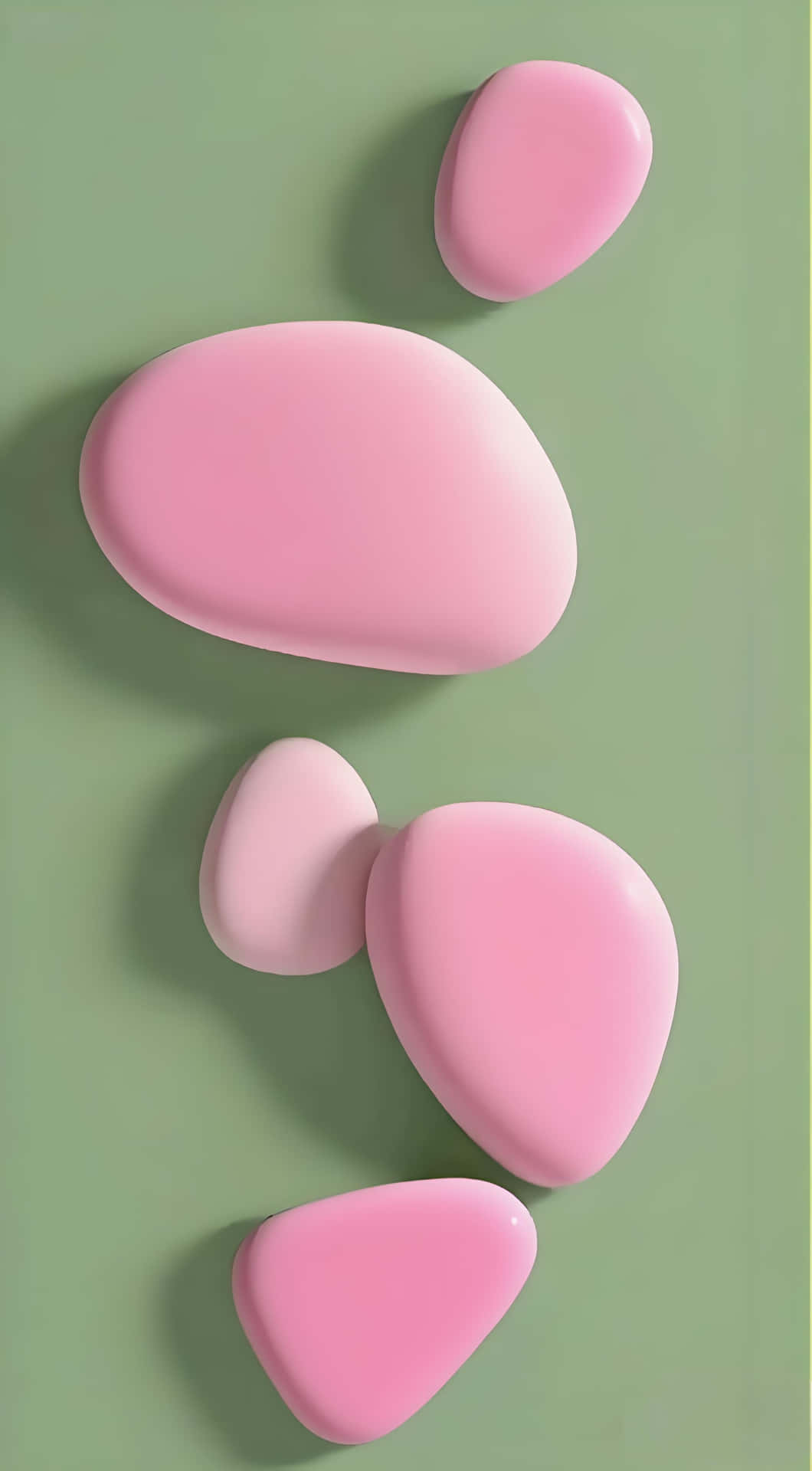 Pink Charm on Green: Sweet 3D Shape Wallpaper 壁紙 — 五顆光滑的粉紅色鵝卵石大小不一，在柔和的綠色背景上對角漂浮，投下柔和陰影。