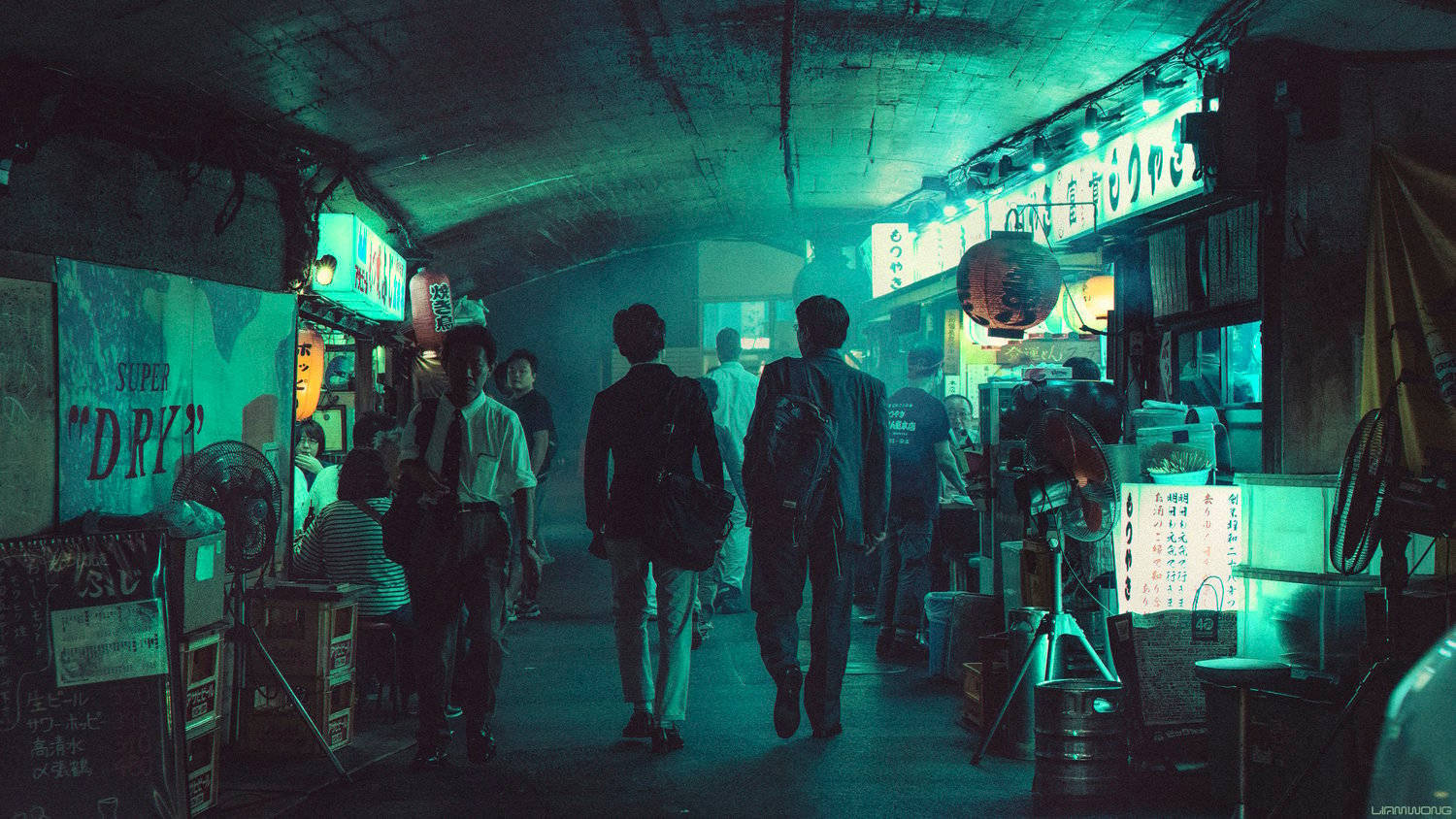 arcade 桌布 壁紙 — 人們在夜晚走過東京一條霓虹燈照亮的地下小巷，有發光的招牌和風扇。