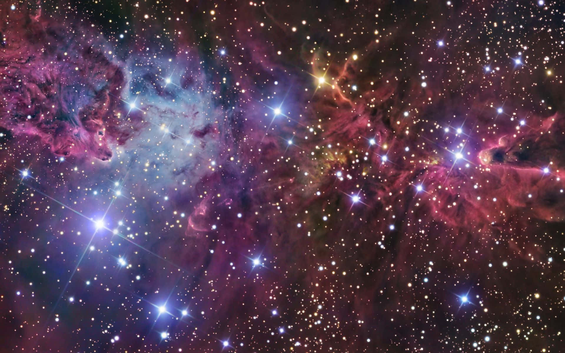Beautiful Space 桌布 壁紙 — 令人嘆為觀止的宇宙星雲景觀，散發著粉紅色、紫色和藍色的光芒，點綴著明亮閃爍的星星。