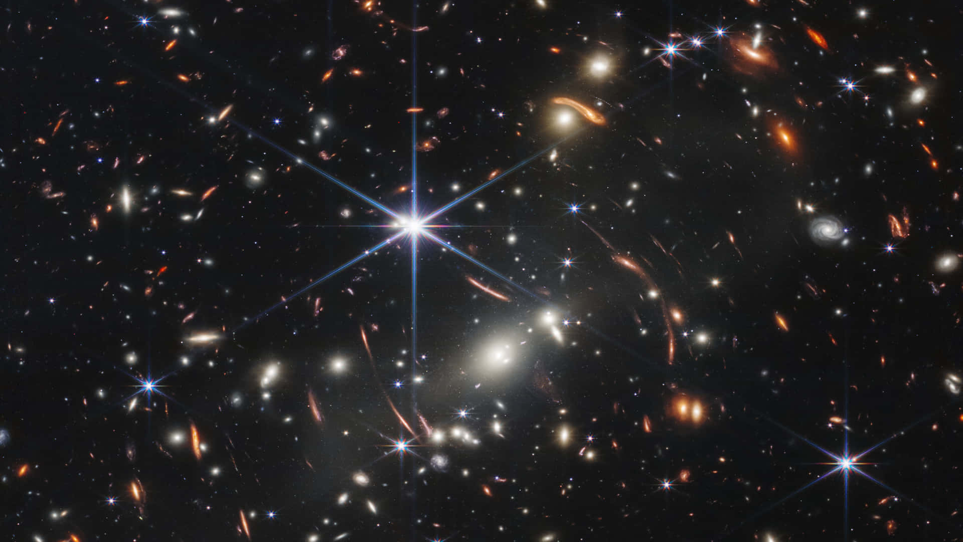 銀河 桌布 壁紙 — 令人嘆為觀止的宇宙景觀，充滿了發光的星系和燦爛的星星，背景是深邃的黑色虛空。