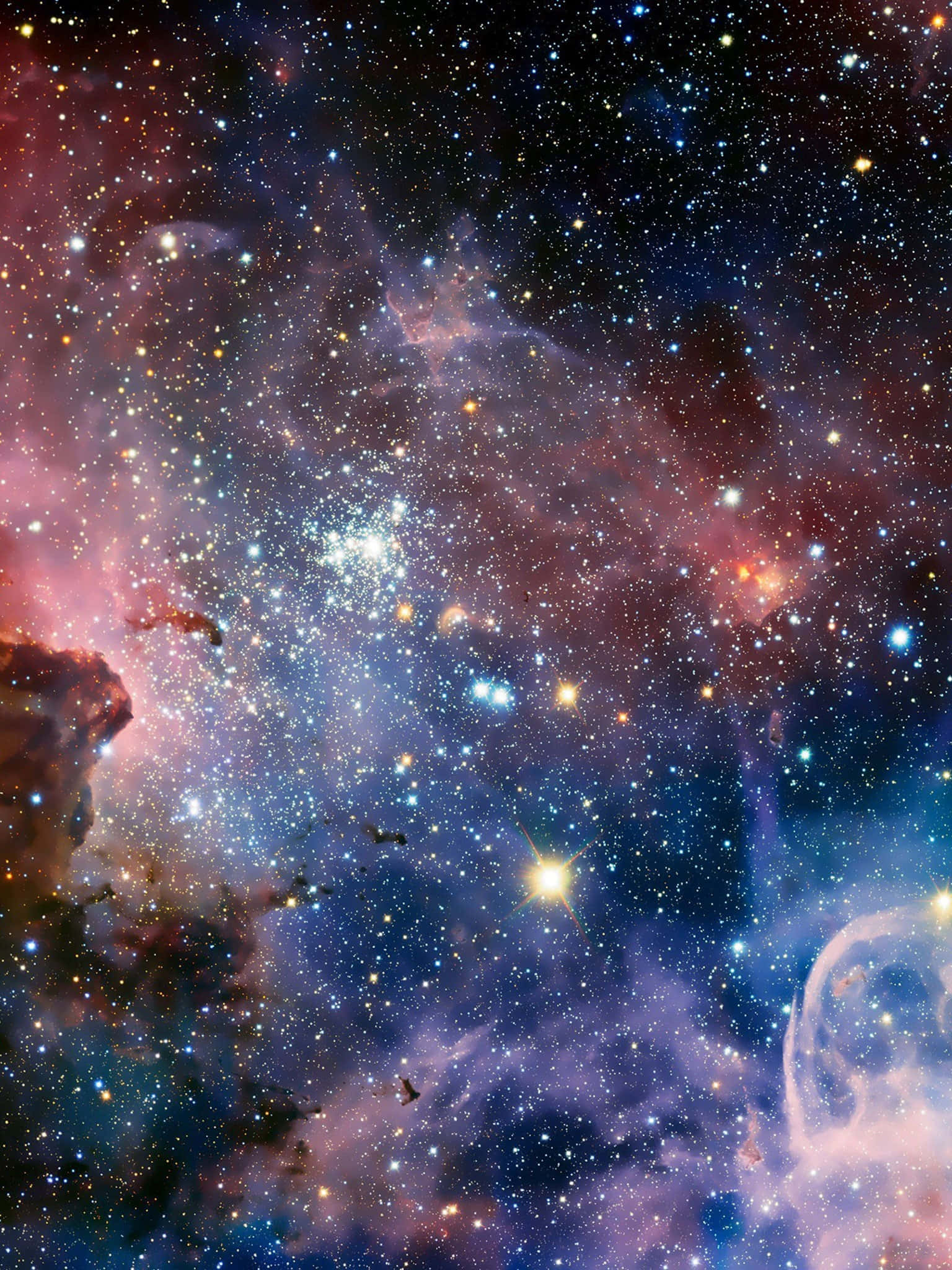 美學 iPad 壁紙 桌布 壁紙 — 令人嘆為觀止的宇宙景觀，閃爍的星雲和無數的星星呈現出鮮豔的藍色、粉紅色和紫色。
