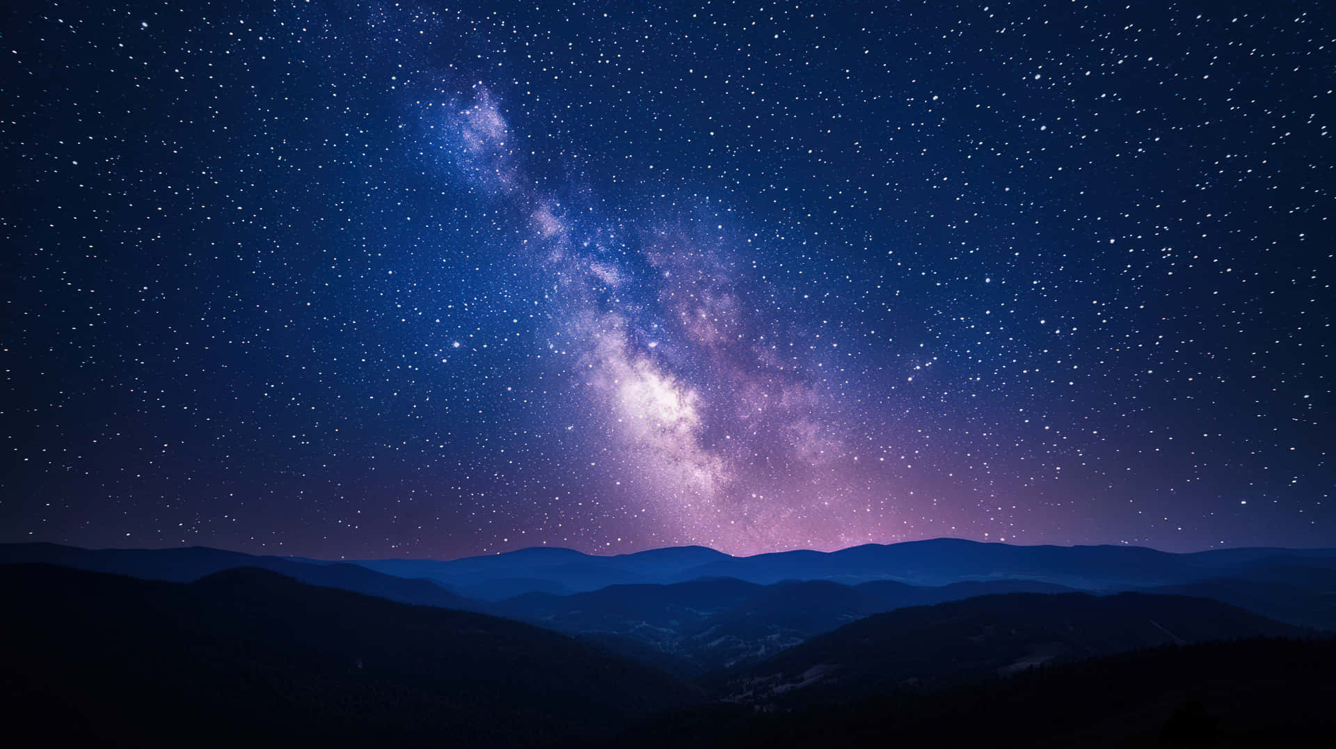 Starry Night Over Mountain Ranges with the Milky Way in the Sky 壁紙 — 令人嘆為觀止的銀河系景觀，在星夜中拱起於剪影般的山脈之上。