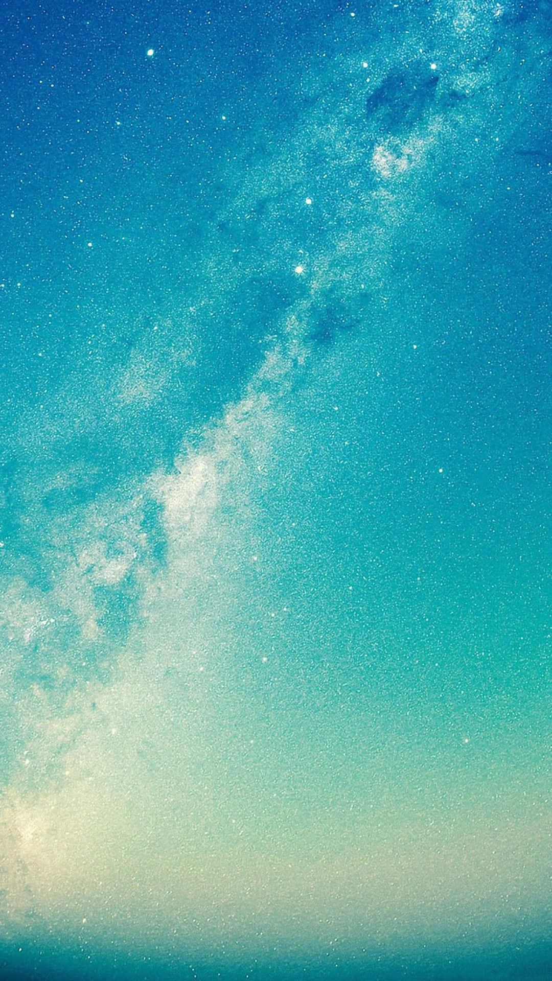 漂亮的動圖 桌布 壁紙 — 令人嘆為觀止的銀河系景觀，在繁星點點的宇宙天空中散發出充滿活力的青綠色和白色光芒。