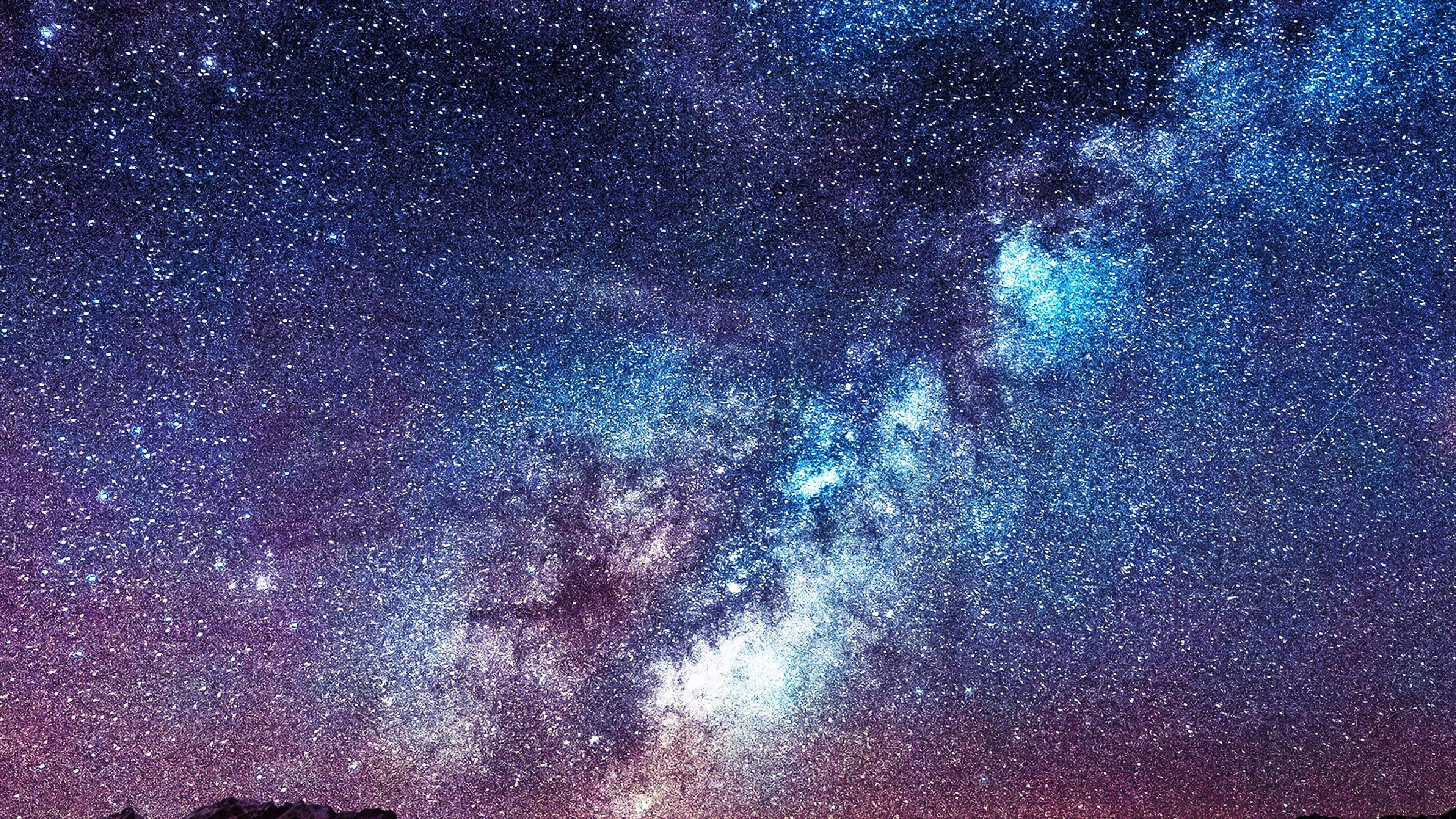 桌布 壁紙 — 令人嘆為觀止的銀河系景觀，在繁星點點的夜空中閃耀著鮮豔的藍色、紫色和白色。