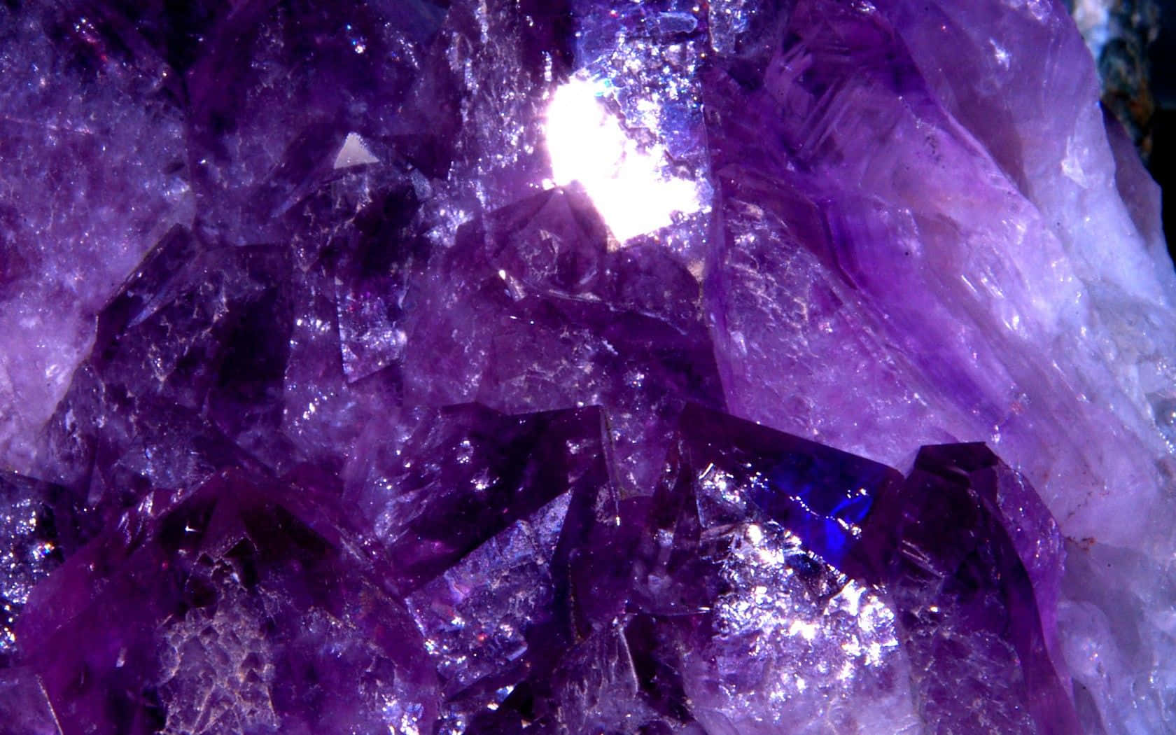 紫水晶 桌布 壁紙 — 令人目眩的紫水晶特寫，呈現鮮豔紫色晶體，內部光芒閃爍，切面銳利。