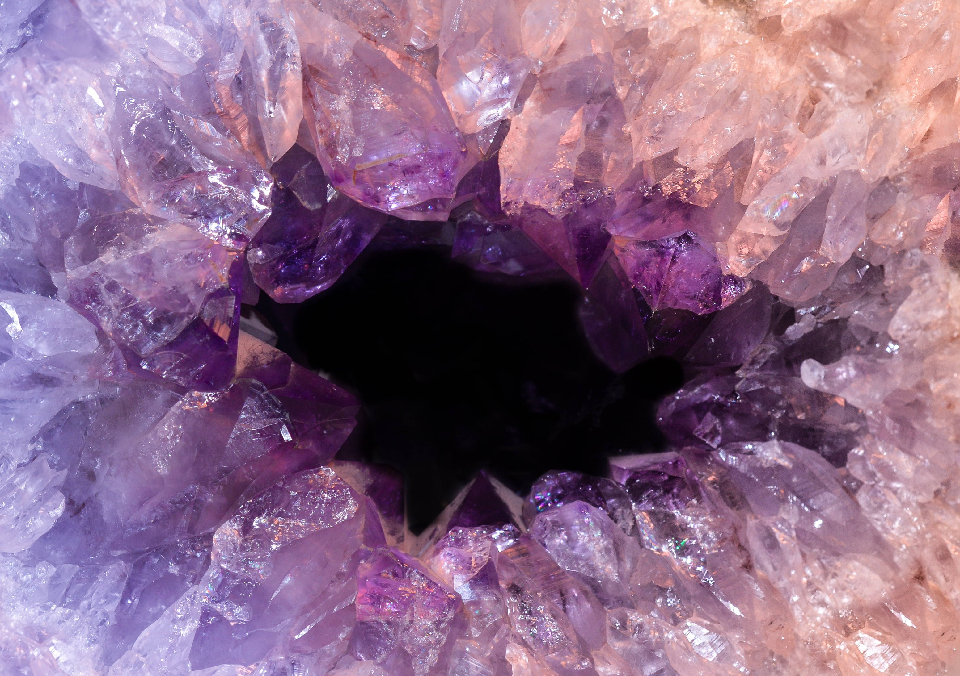 紫水晶 桌布 壁紙 — 令人驚嘆的紫水晶晶洞特寫，鋸齒狀的紫色晶體向內輻射至黑暗空心中心。