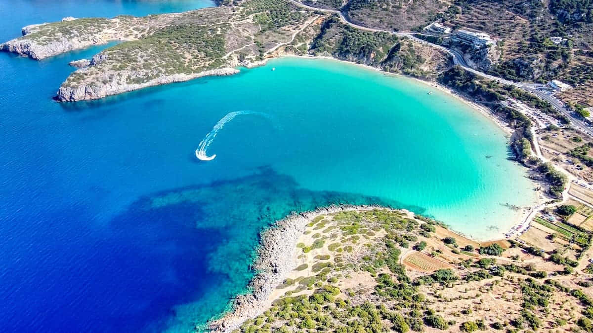 Greek Island 桌布 壁紙 — 俯瞰碧綠海灣，水上滑水軌跡蜿蜒穿過深藍色海水。