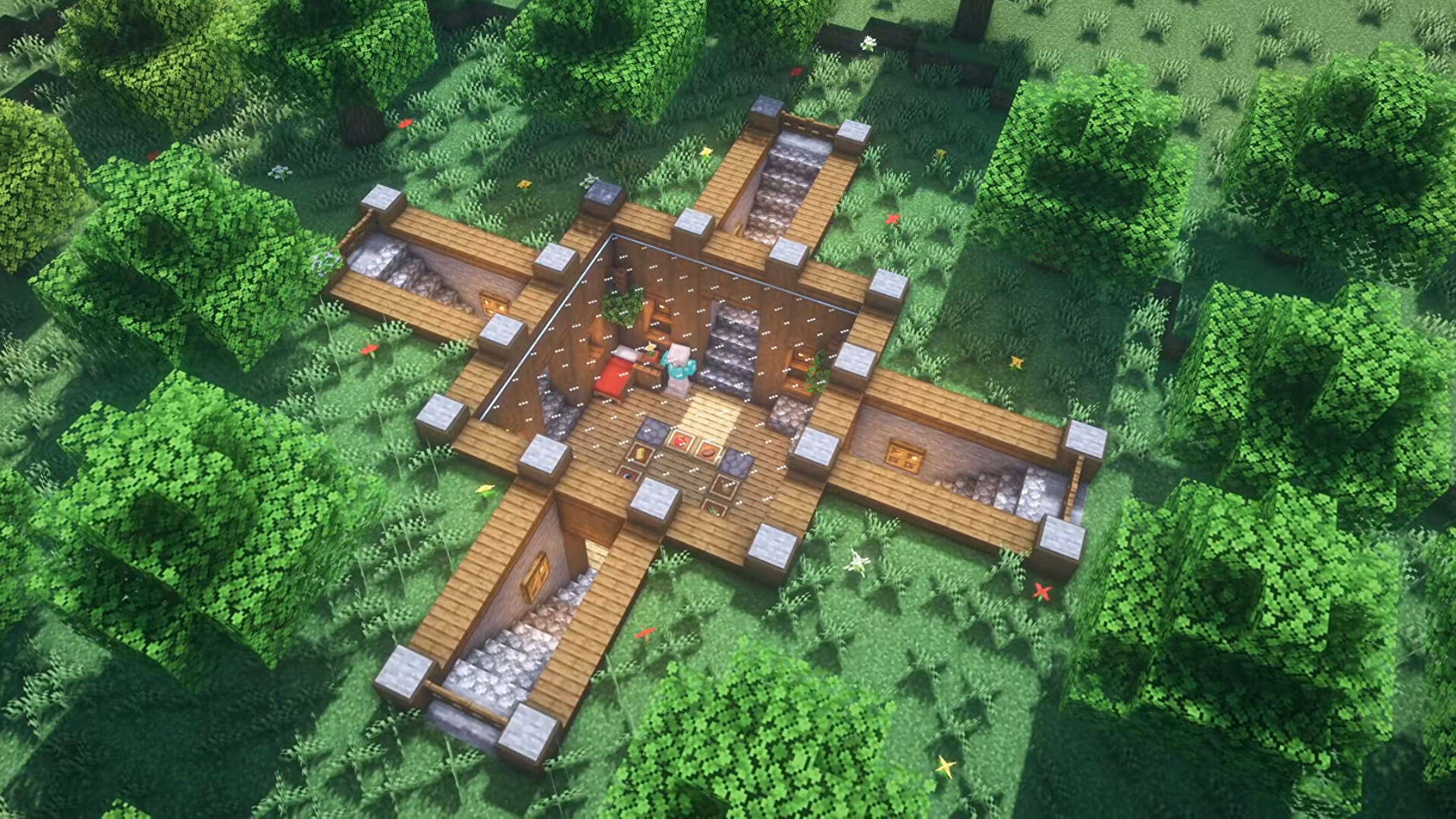 最佳我的世界 桌布 壁紙 — 俯瞰視角，一座木製十字形Minecraft房屋，帶有石頭點綴，坐落於茂密的綠色森林中。