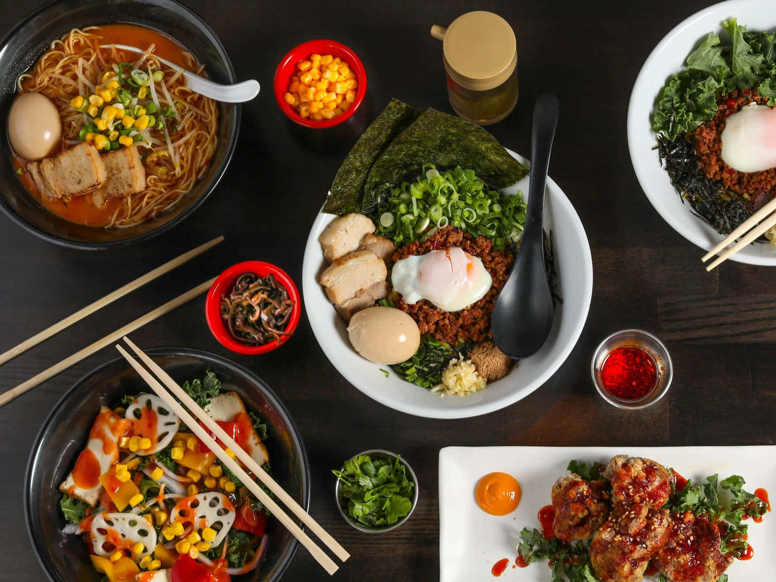 Noodles 桌布 壁紙 — 俯瞰視角下色彩繽紛的亞洲菜餚，包括拉麵、韓式拌飯和辣味雞肉，飾以新鮮蔬菜和色彩豐富的配料。
