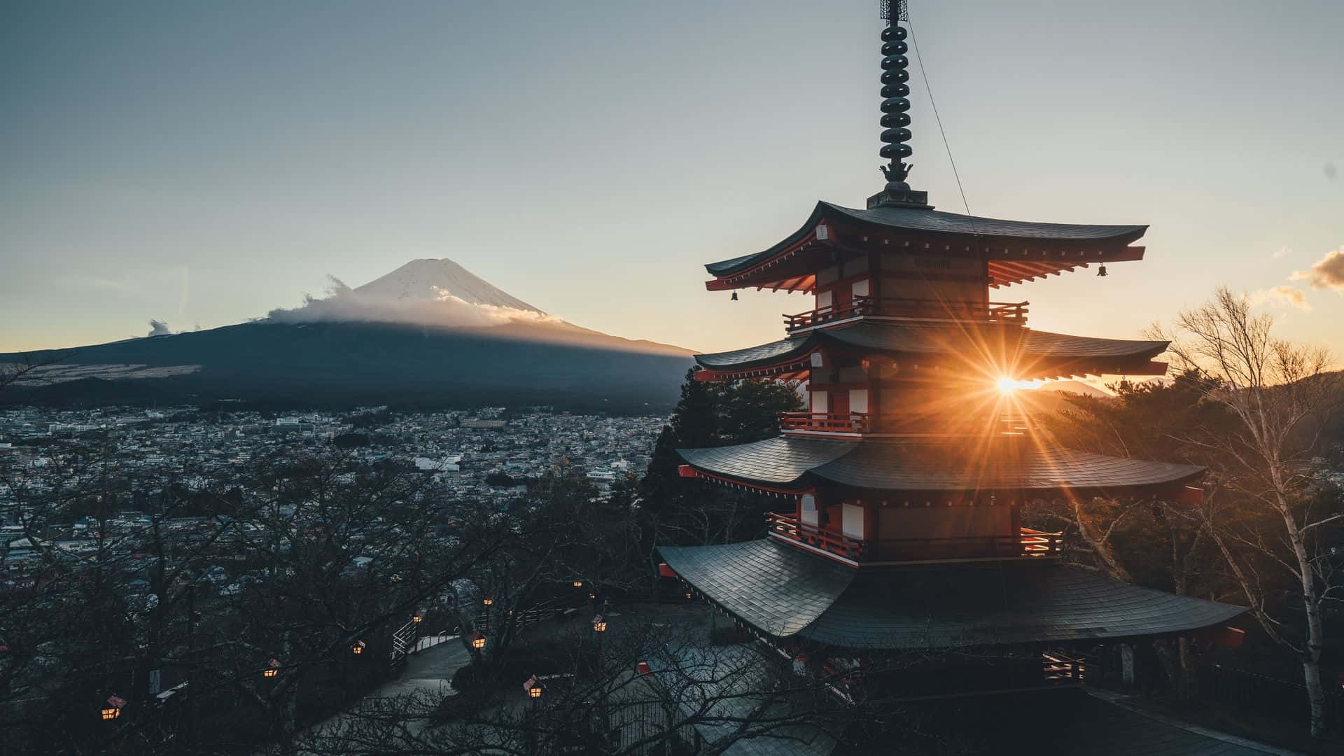 桌布 壁紙 — 傳統日本寶塔在夕陽餘暉中呈現剪影，遠方可見富士山。