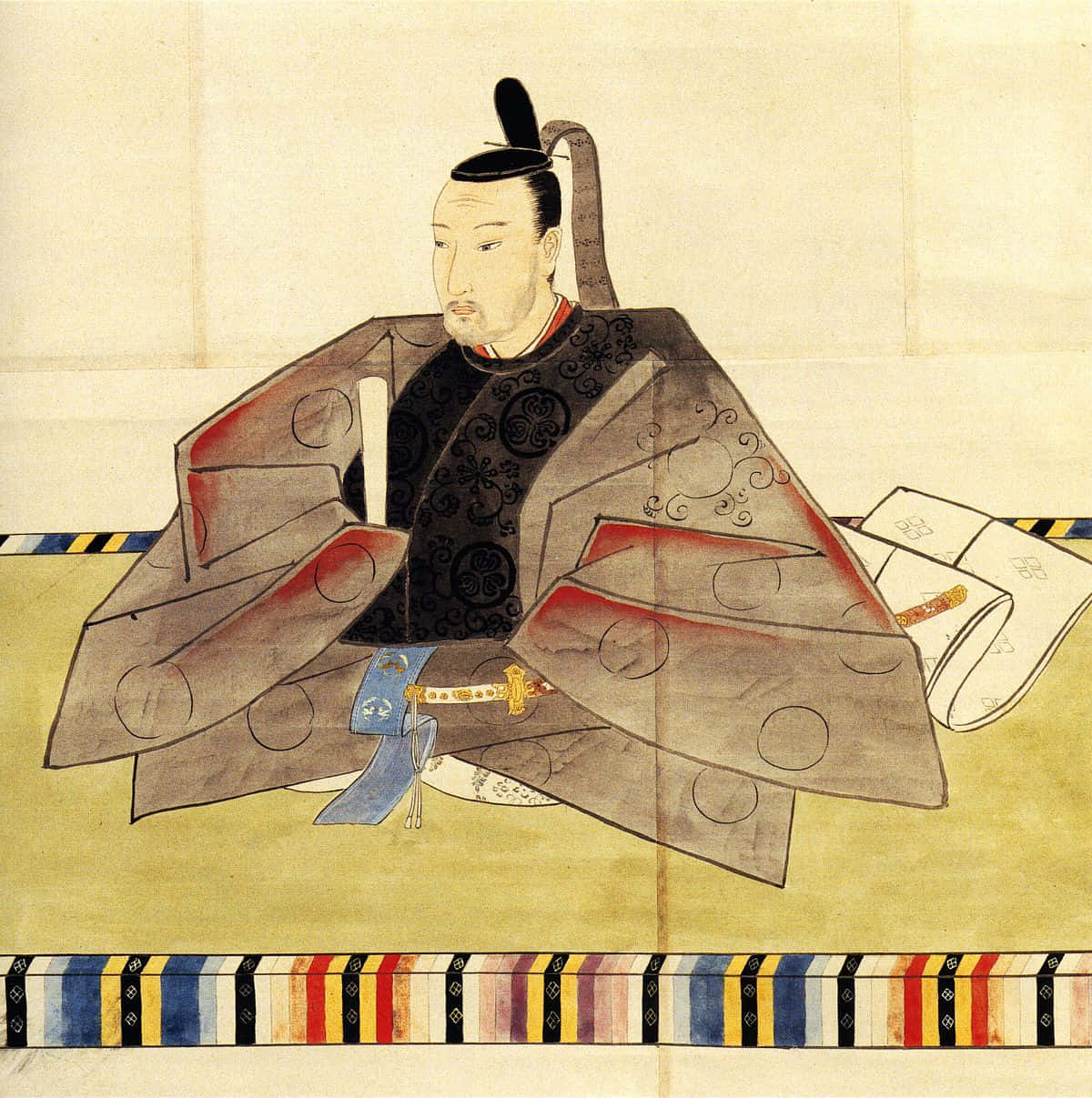 Tokugawa 桌布 壁紙 — 傳統日本武士肖像，身穿正式服裝，坐在有圖案的地板上，身旁放著一把刀。