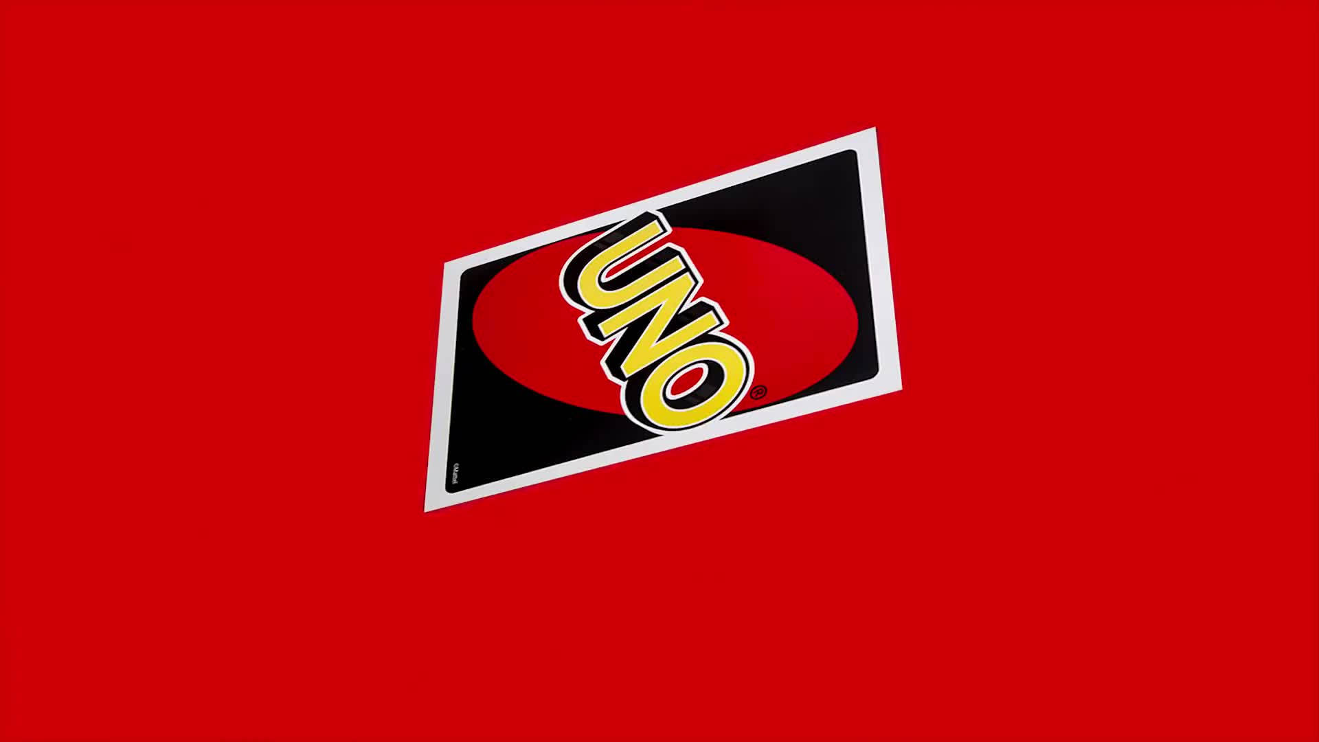 Uno 桌布 壁紙 — 傾斜的Uno卡牌標誌，紅色橢圓形上有粗體黃色字母，背景為純紅色。
