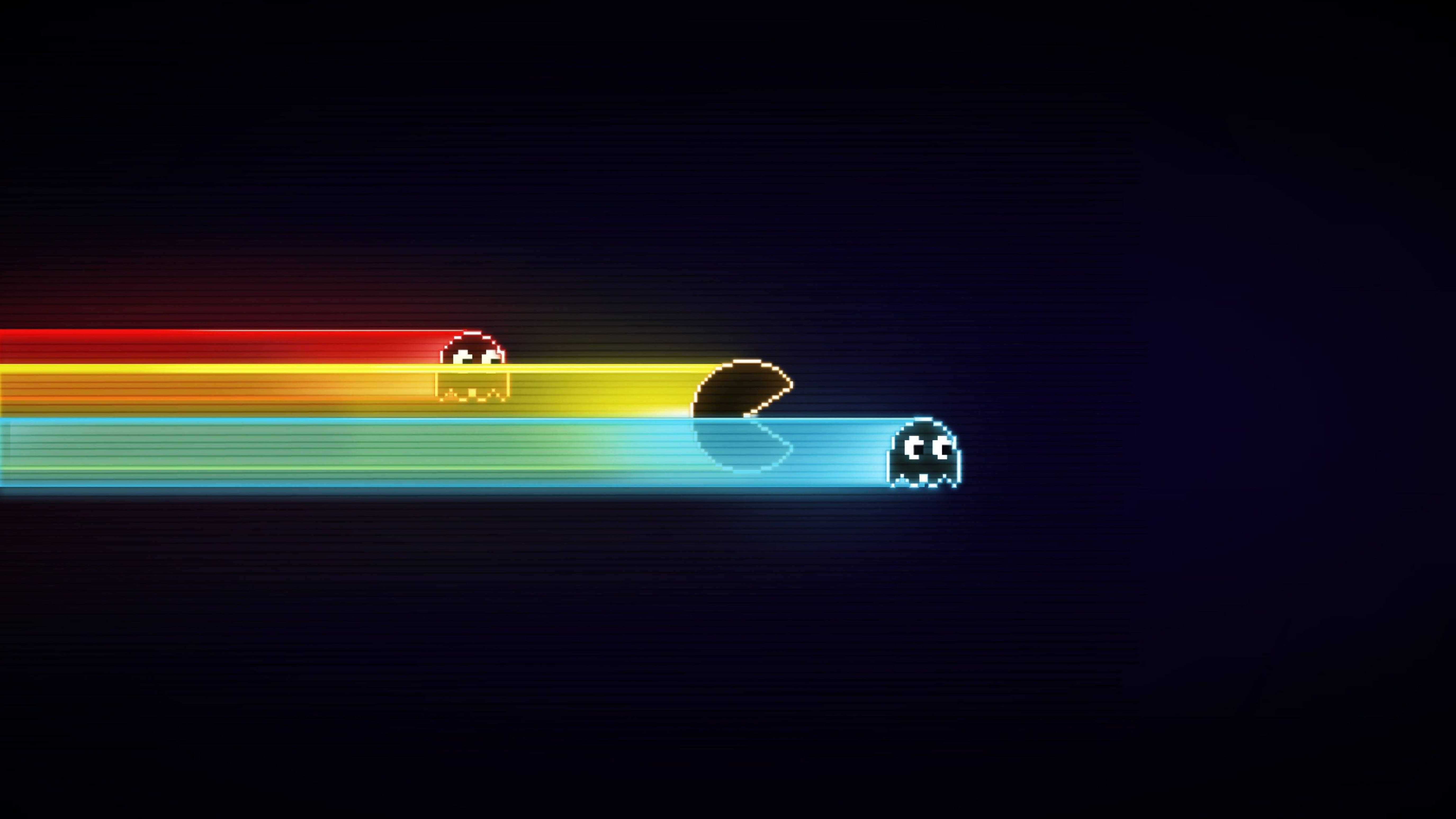 pac man 桌布 壁紙 — 像素化的 Pacman 和鬼魂在黑暗背景上追逐發光彩虹軌跡。
