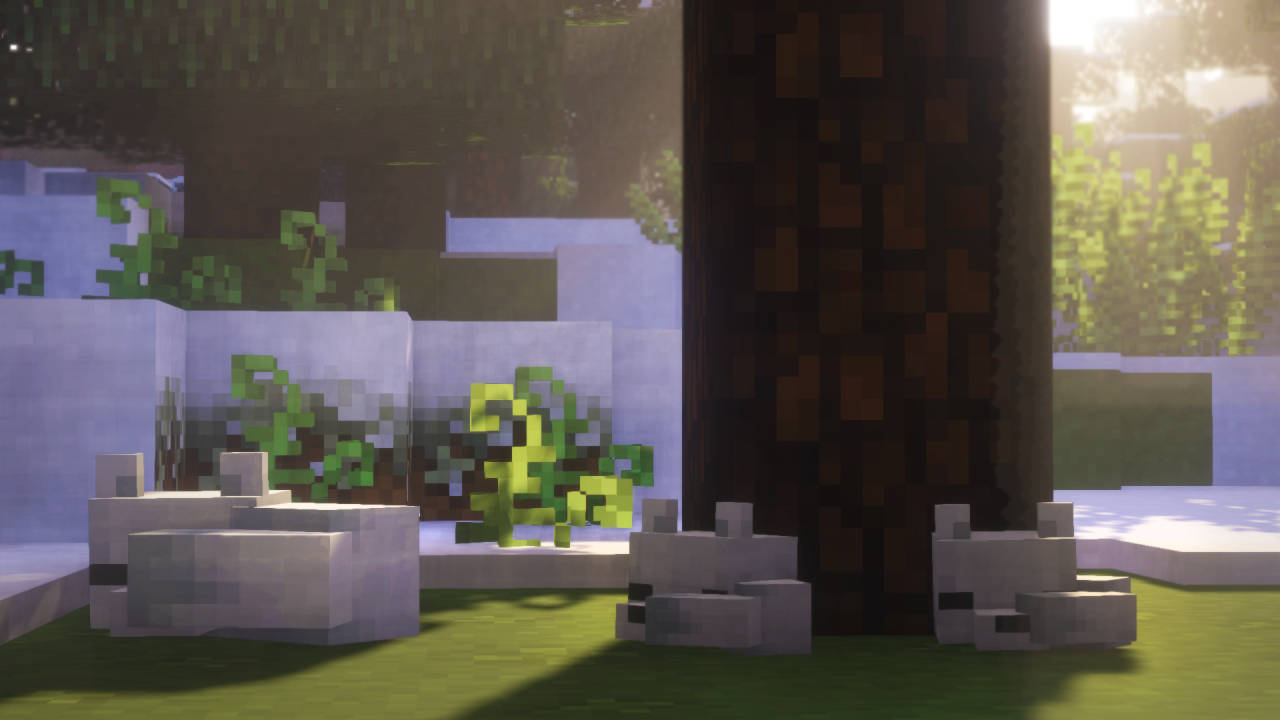 自然風景動圖 桌布 壁紙 — 像素化的Minecraft兔子在陽光明媚的草地生物群落中，在一棵樹下休息，周圍有方塊狀的樹葉和石頭建築。