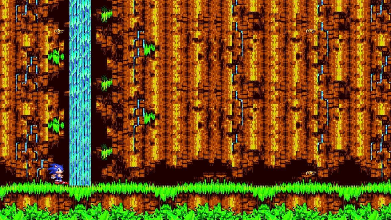 Sonic Cd 桌布 壁紙 — 像素化的藍色刺蝟站在發光的藍色瀑布底部，下方是熾熱的橙色峽谷，底部有綠色草地。