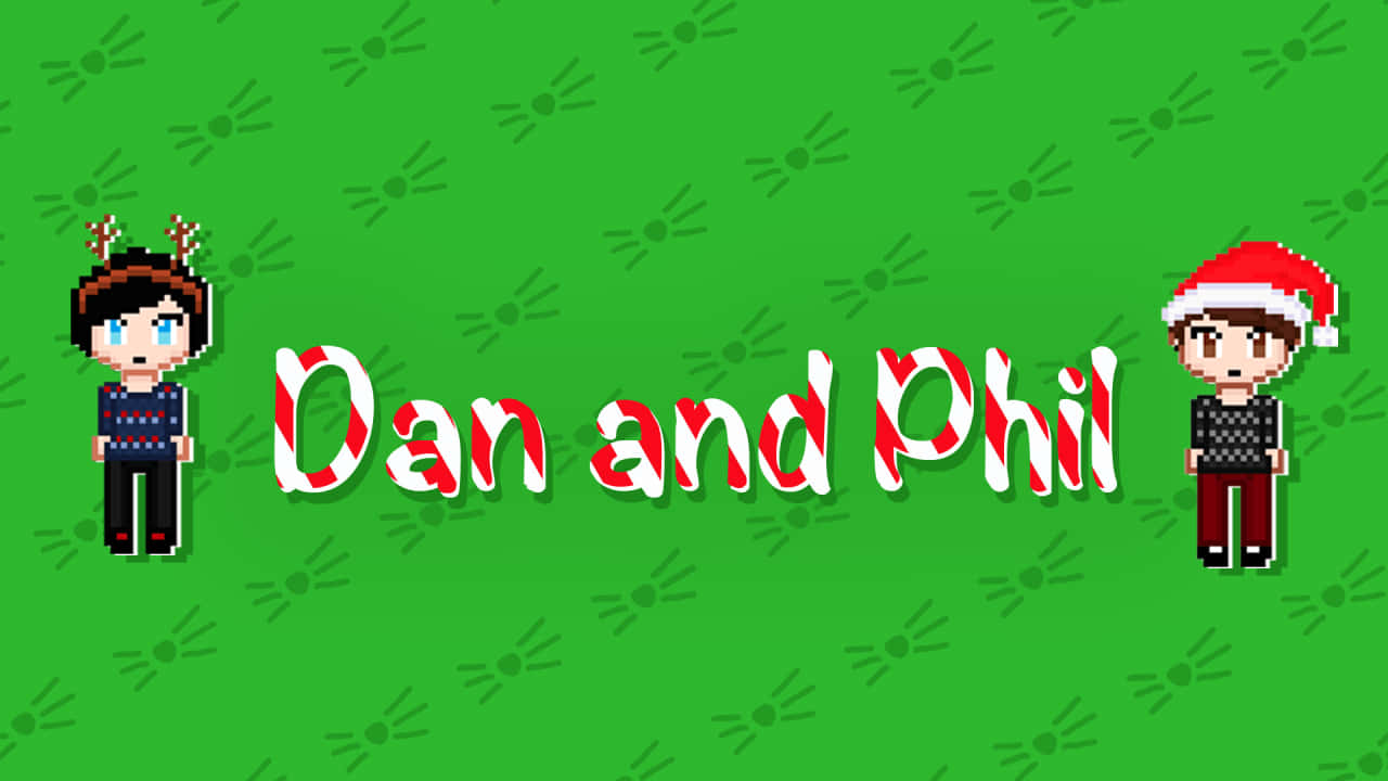 聖誕節 桌布 壁紙 — 像素藝術角色 Dan 和 Phil 穿著節日毛衣，站在綠色背景上，帶有拐杖糖文字。