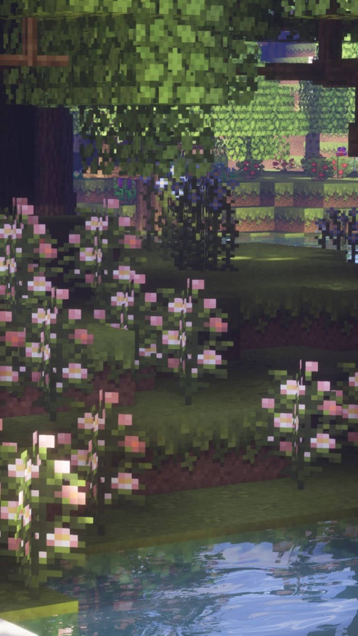 Animated 桌布 壁紙 — 像素風格花園，有粉紅色花朵和綠色樹木，旁邊是平靜的水面，Minecraft風格。