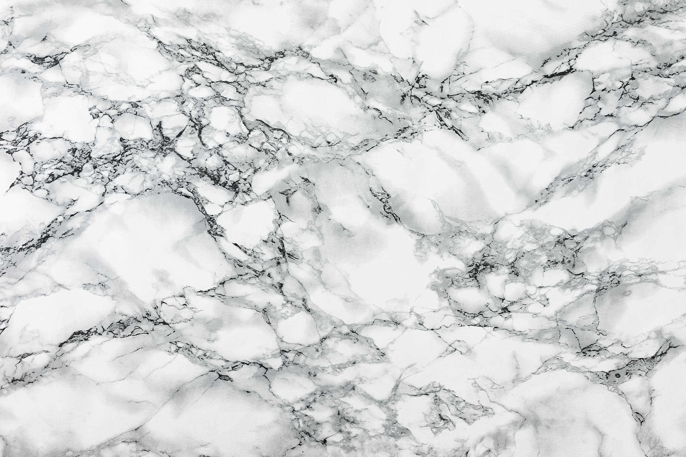 White Marble 桌布 壁紙 — 優雅白色大理石的特寫，帶有複雜的灰色紋理，營造出奢華的天然石材質感。