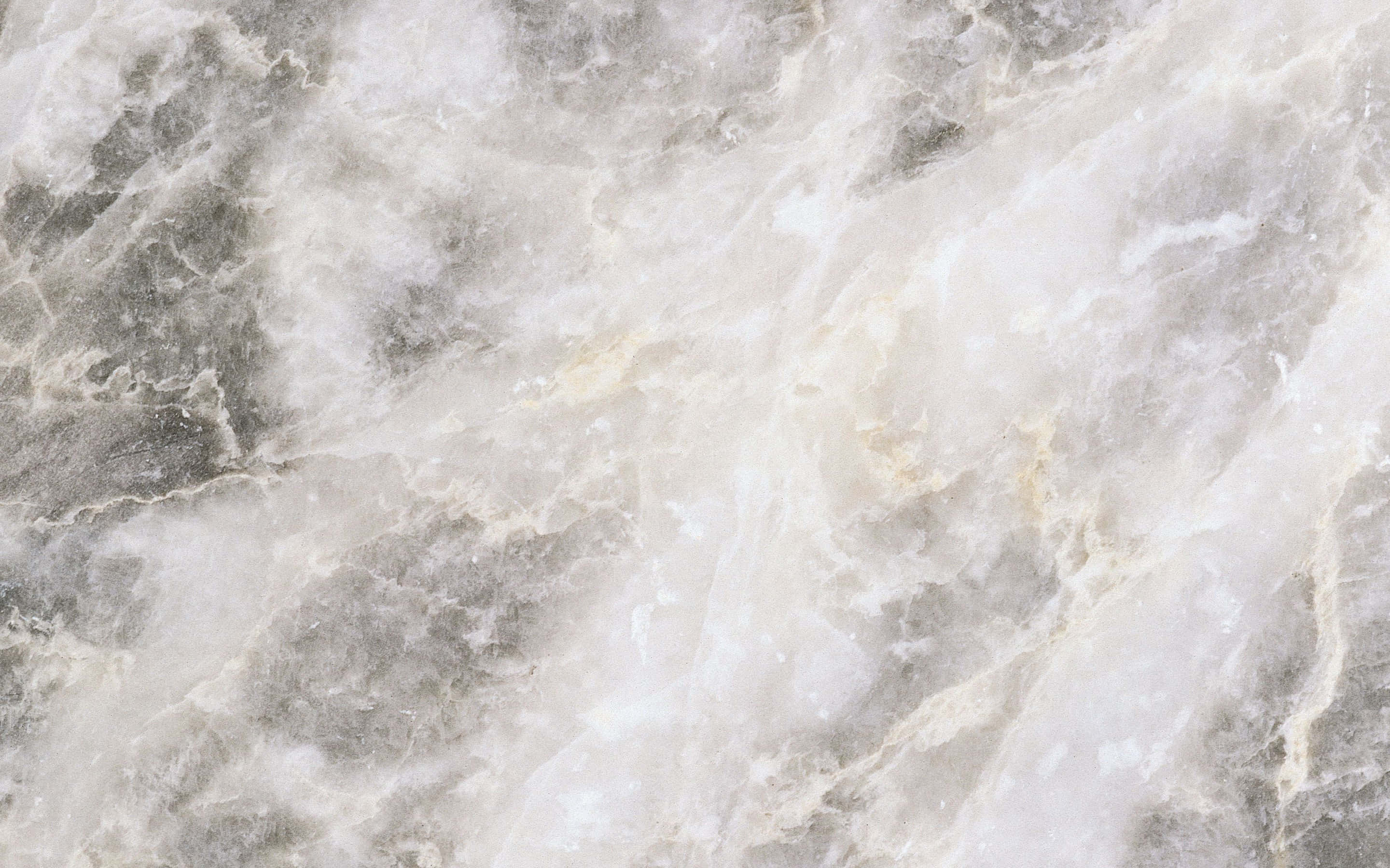 White Marble 桌布 壁紙 — 優雅白色大理石的近距離特寫，帶有旋轉的灰色和金色紋理，營造出奢華的自然圖案。