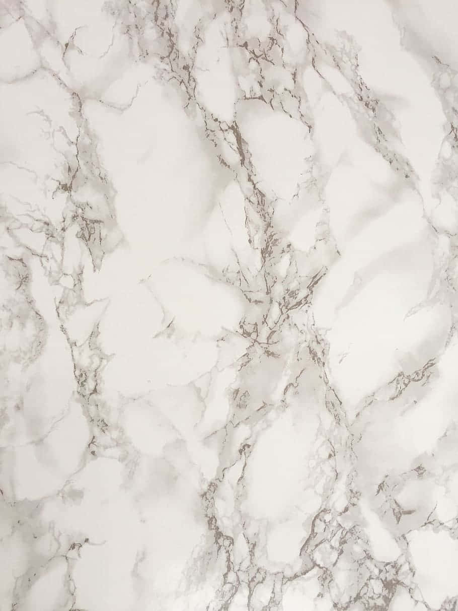Best Marble 桌布 壁紙 — 優雅白色大理石的近距離特寫，帶有複雜的灰色紋理，營造出奢華的自然圖案。