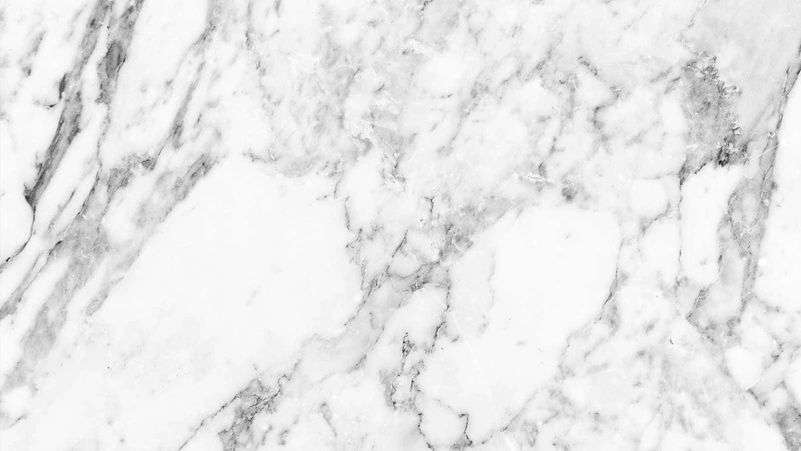 Marble Macbook 桌布 壁紙 — 優雅白色大理石的近距離特寫，帶有旋轉的灰色紋理，營造出奢華的天然石材質感。
