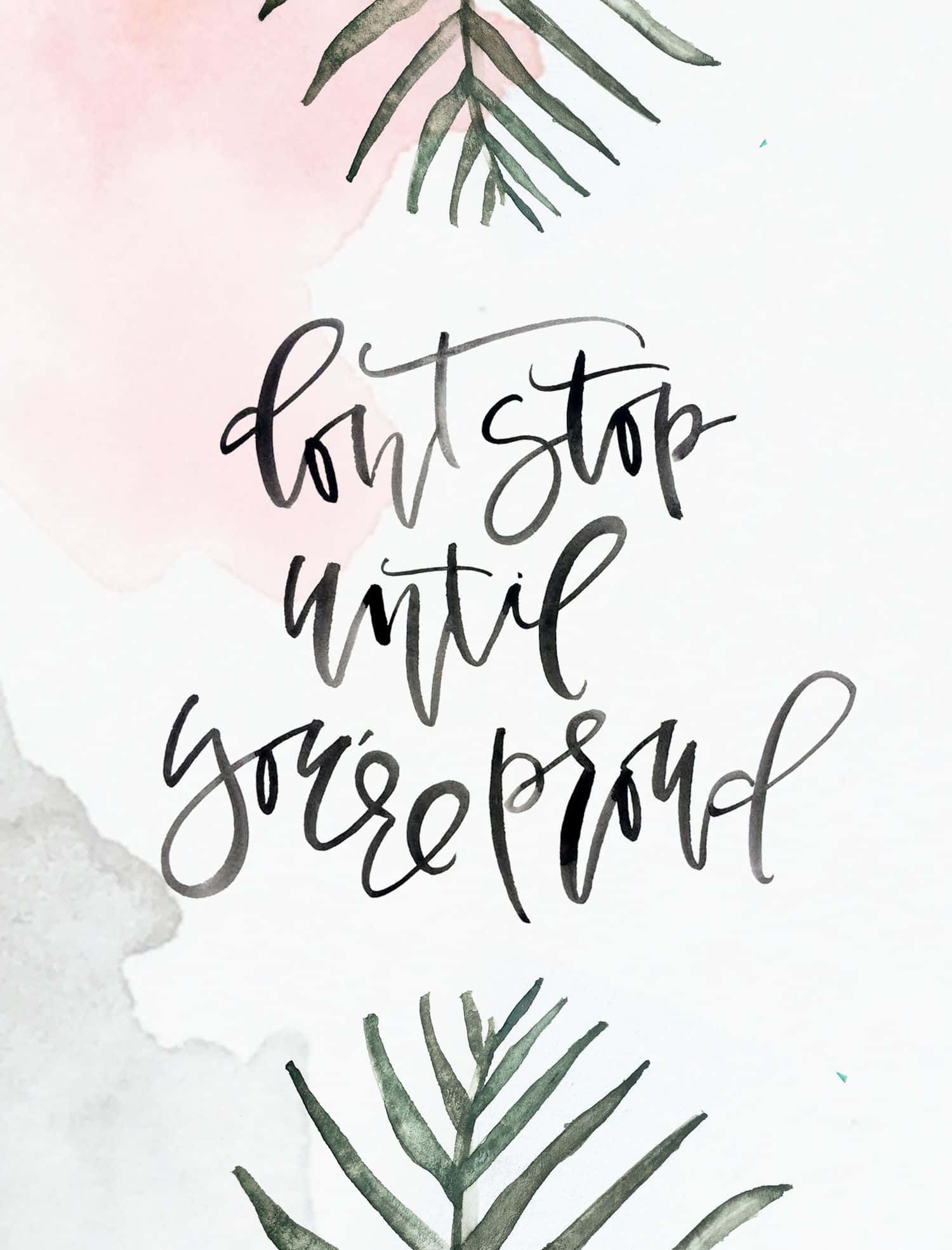 Quote 桌布 壁紙 — 優雅的水彩藝術作品，以流暢的黑色字體呈現「don't stop until you're proud」這句話，並以綠色蕨類植物圍繞，背景為柔和的粉紅色和灰色水彩洗滌。