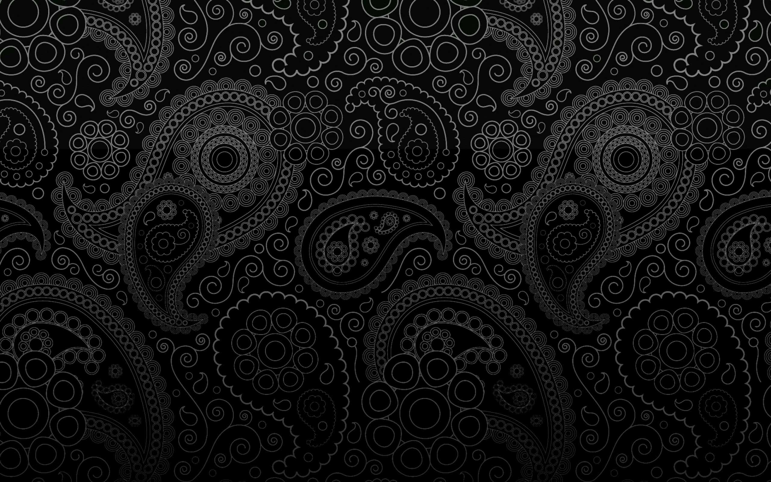 Screen 桌布 壁紙 — 優雅的白色佩斯利圖案在深黑色背景上複雜地旋轉，形成無縫重複的設計。